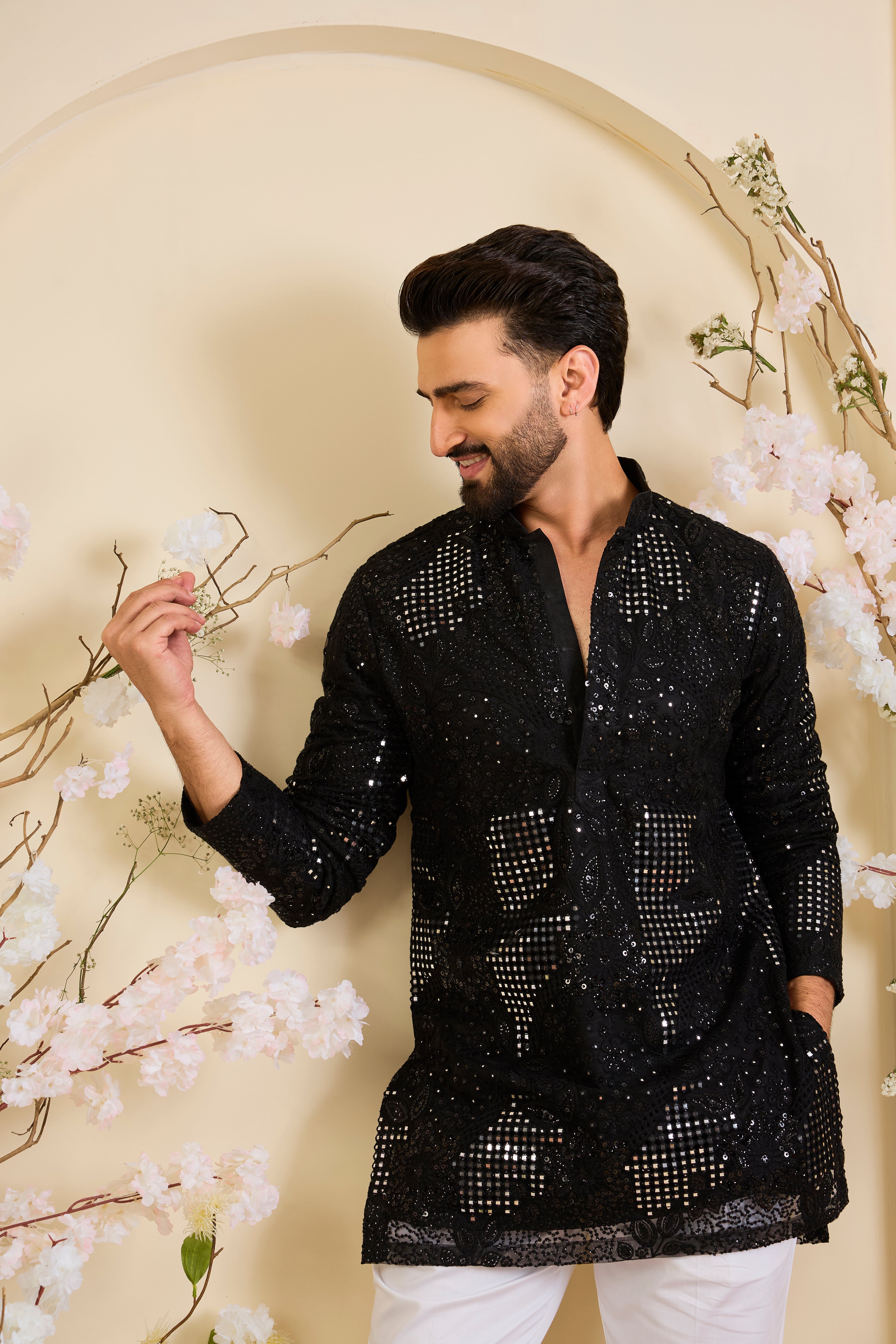 Black short kurta with sequin mirrorwork and delicate floral embroidery, offering a refined, luminous, and effortlessly sophisticated statement.