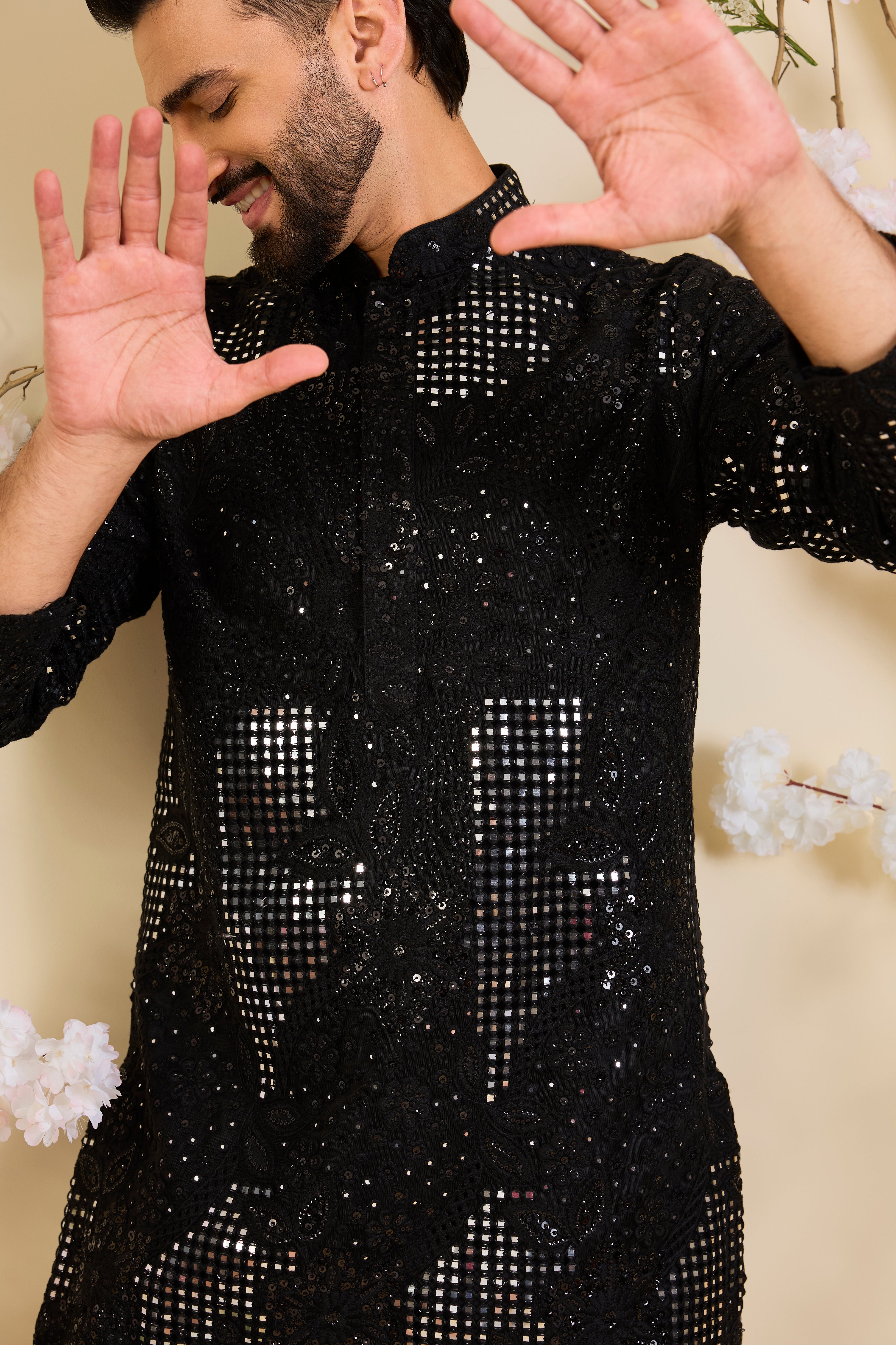 Black short kurta with sequin mirrorwork and delicate floral embroidery, offering a refined, luminous, and effortlessly sophisticated statement.
