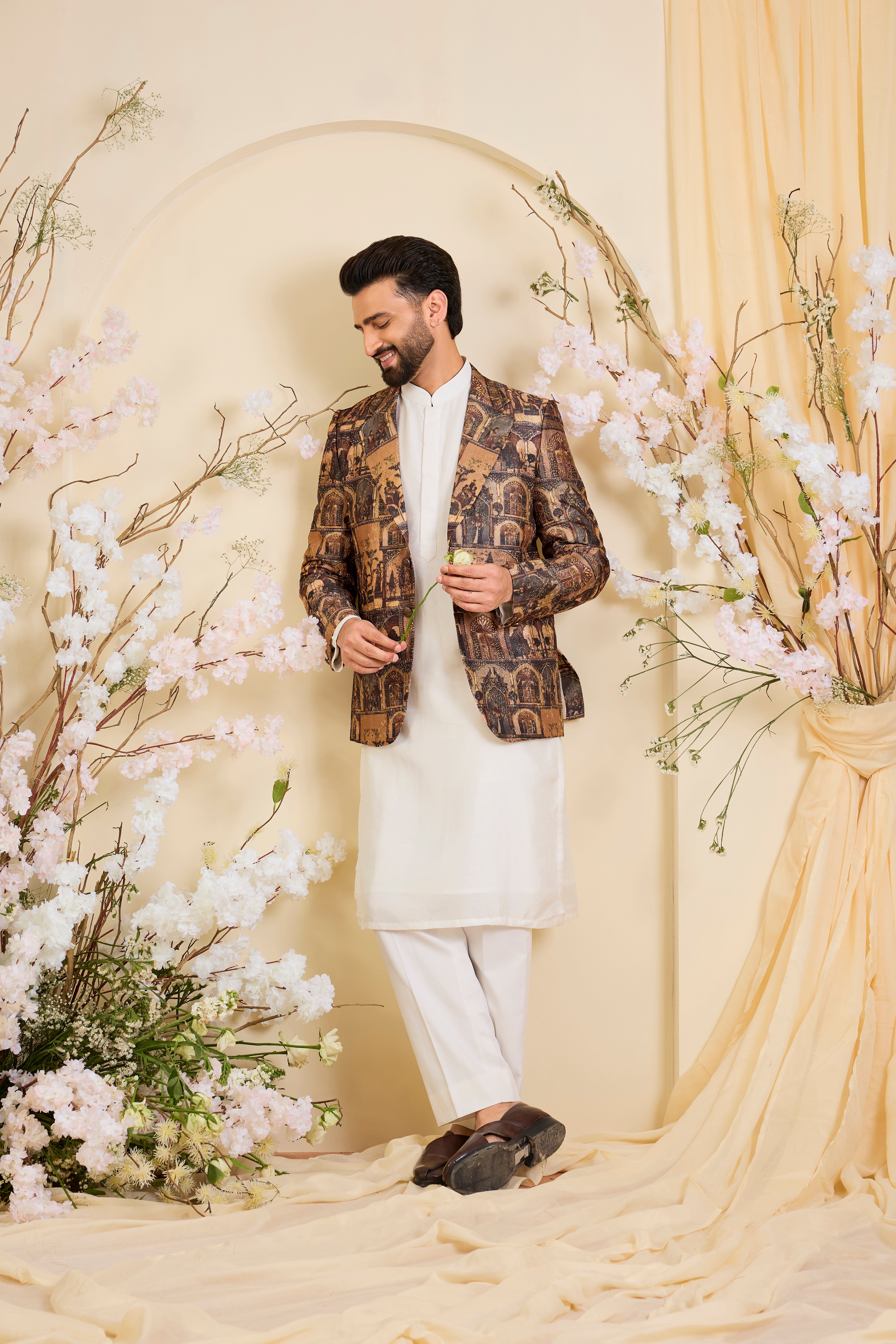 Brown blazer featuring detailed Mughal figures and courtly scenes, elevated with fine aari embroidery for a refined, heritage-rich expression.