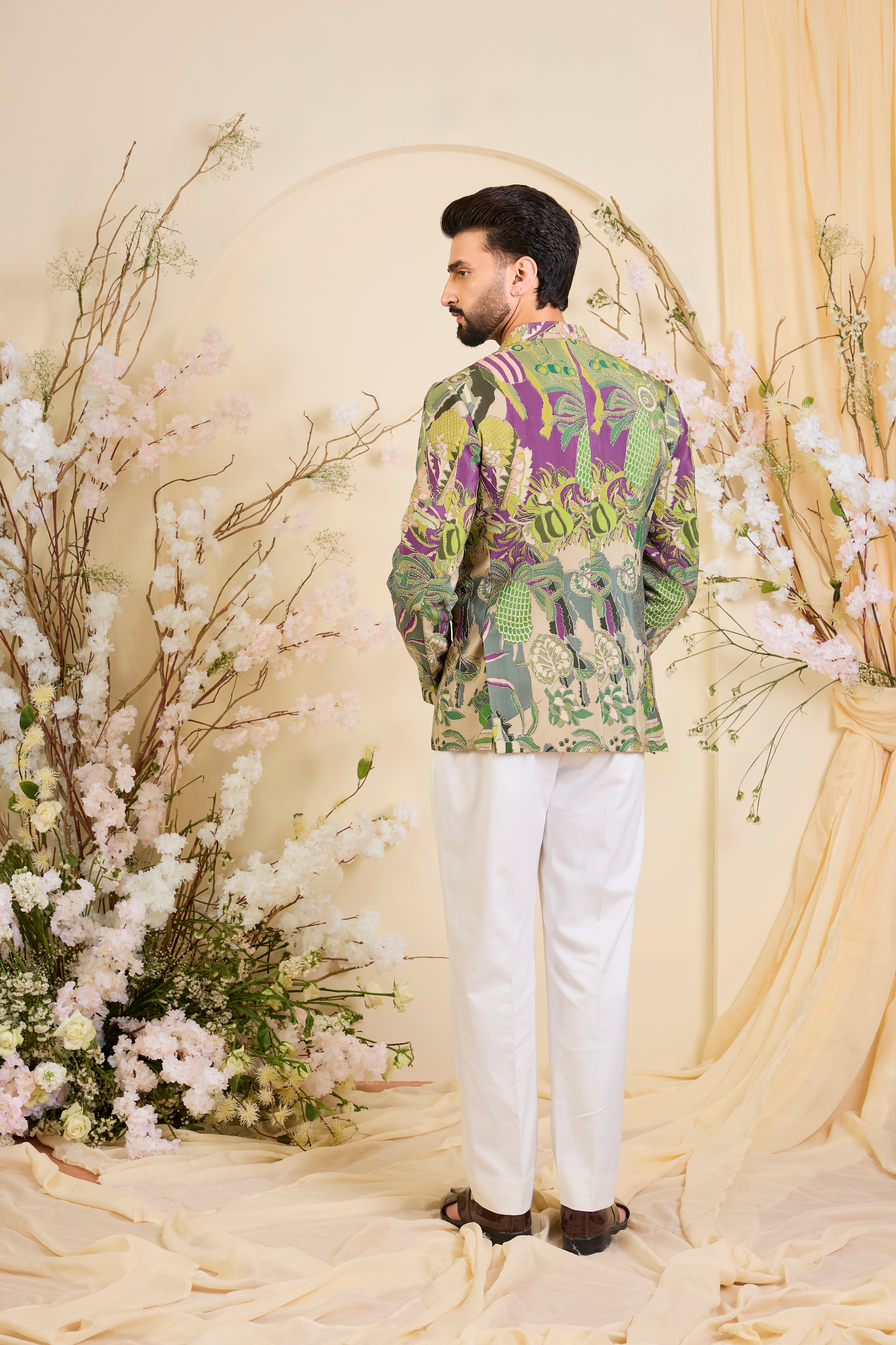 Green abstract bandhgala with detailed multicolour prints and intricate zari accents, blending artistic expression with refined, modern elegance.
