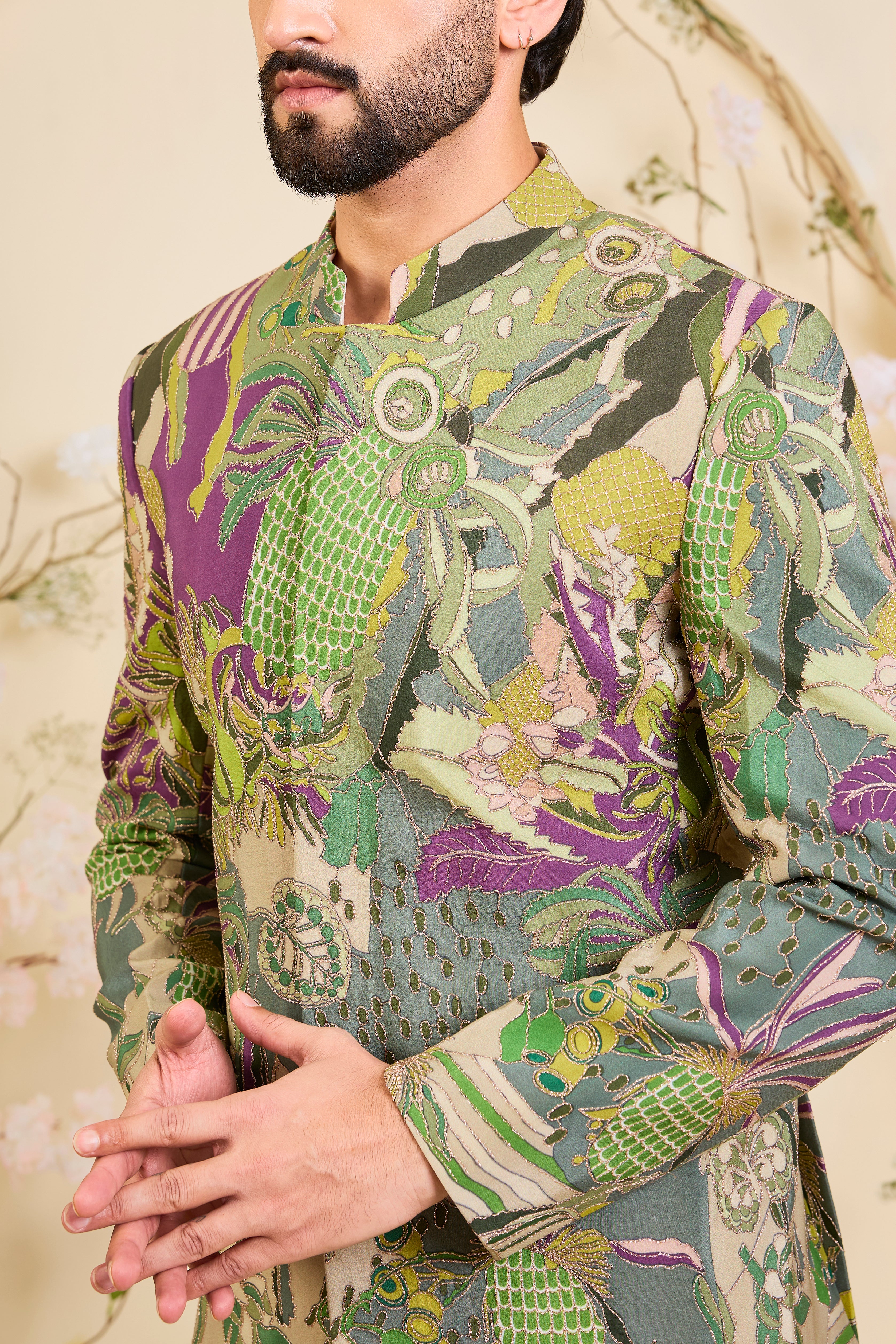 Green abstract bandhgala with detailed multicolour prints and intricate zari accents, blending artistic expression with refined, modern elegance.