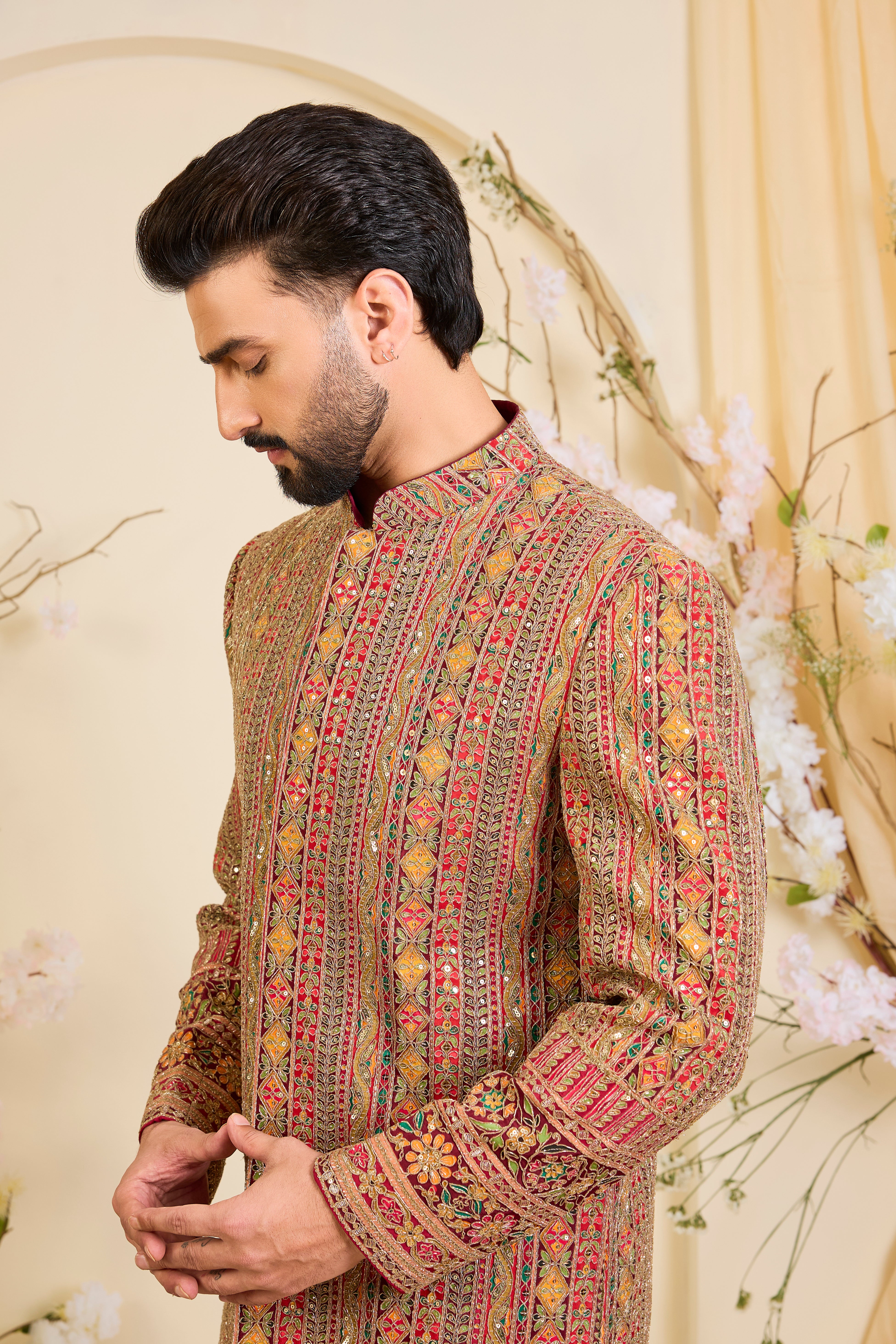 Pink base sherwani with heavy zari embroidery, intricate sequins, and multicolour prints, crafted for bold, opulent, statement-making occasions.