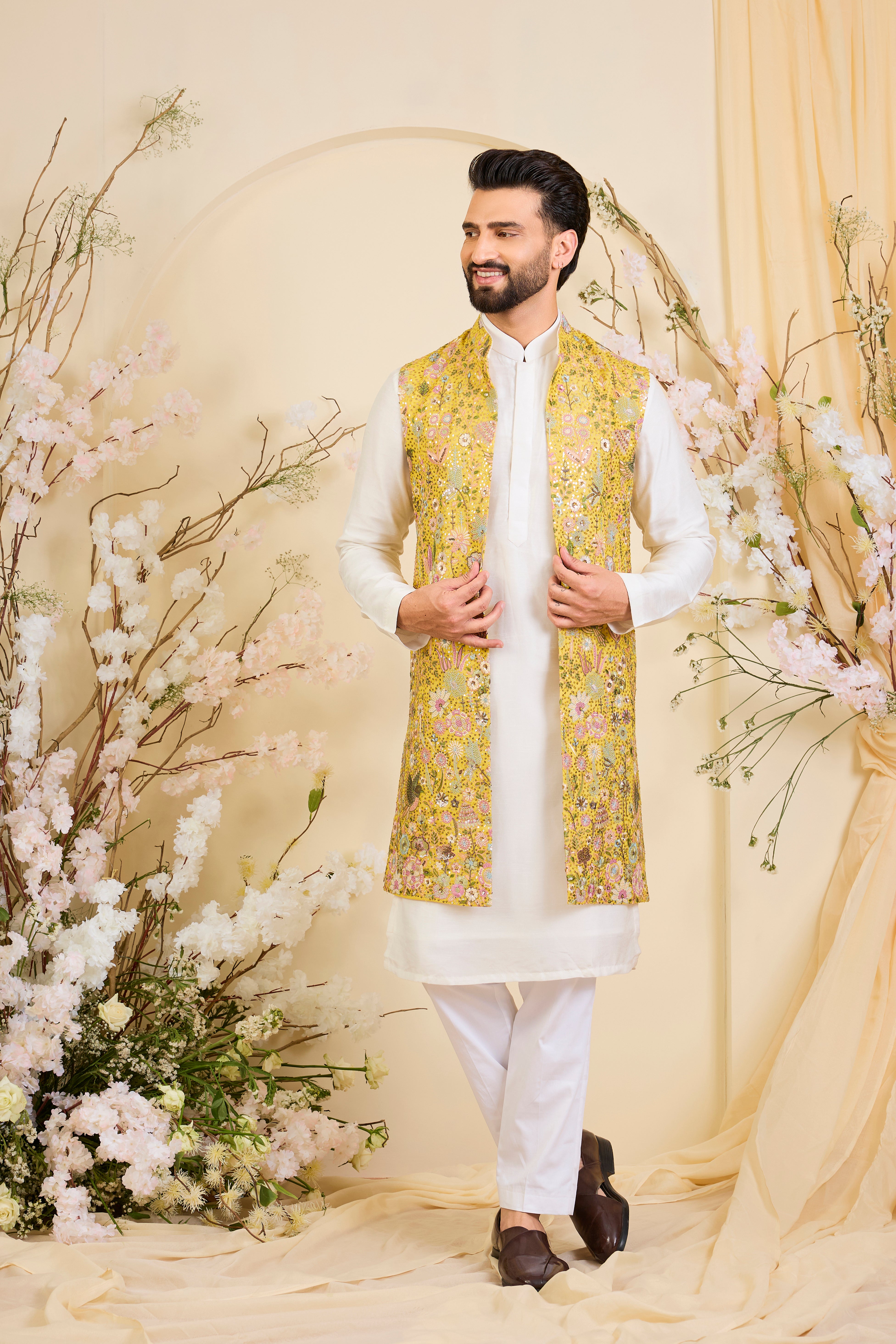 Yellow long open jacket with intricate sequin work and detailed flora-fauna motifs, offering a luminous, richly layered couture statement.