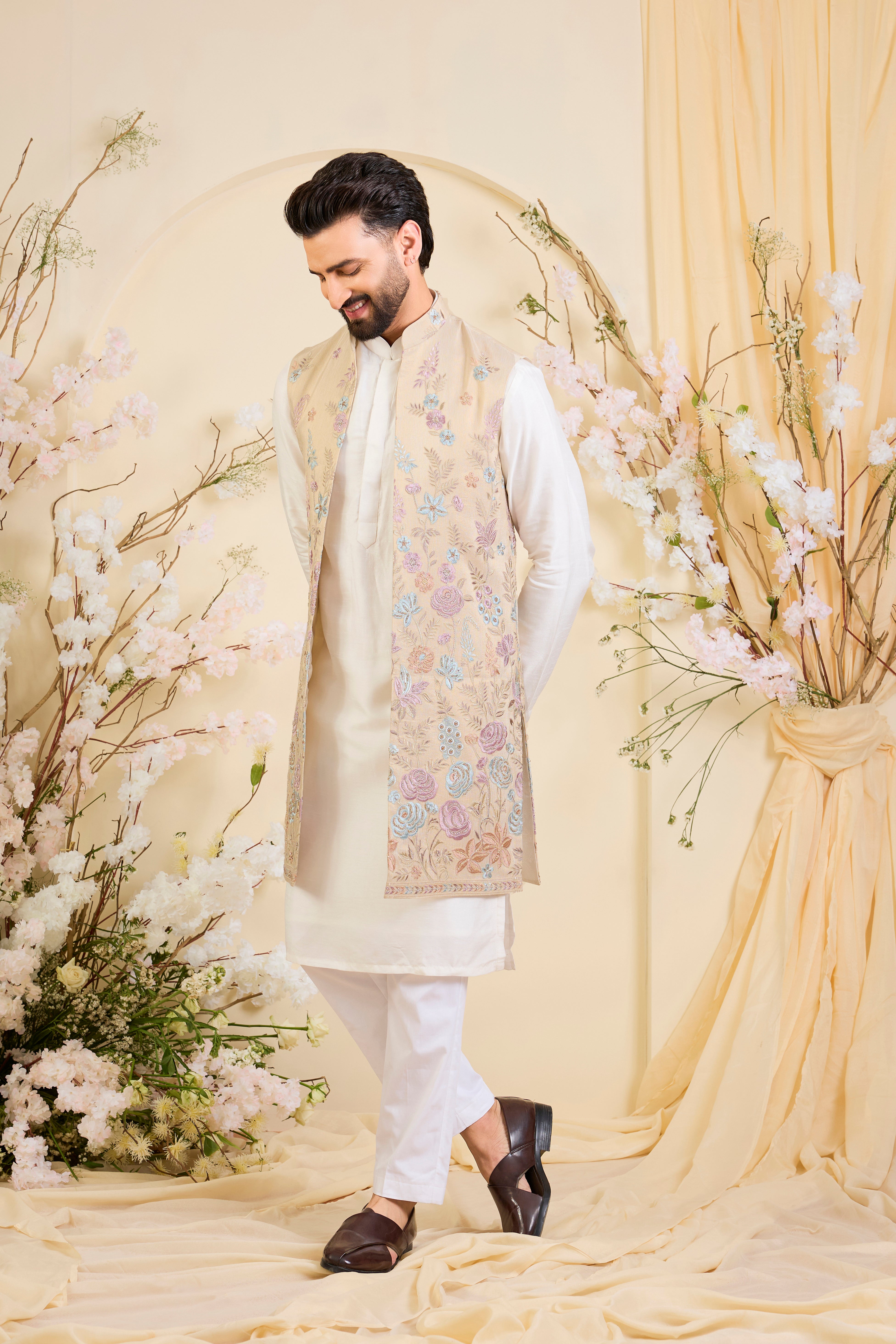 Beige-gold long open jacket with intricate multicolour floral embroidery and delicate cut dana work, offering a refined, luminous couture statement.