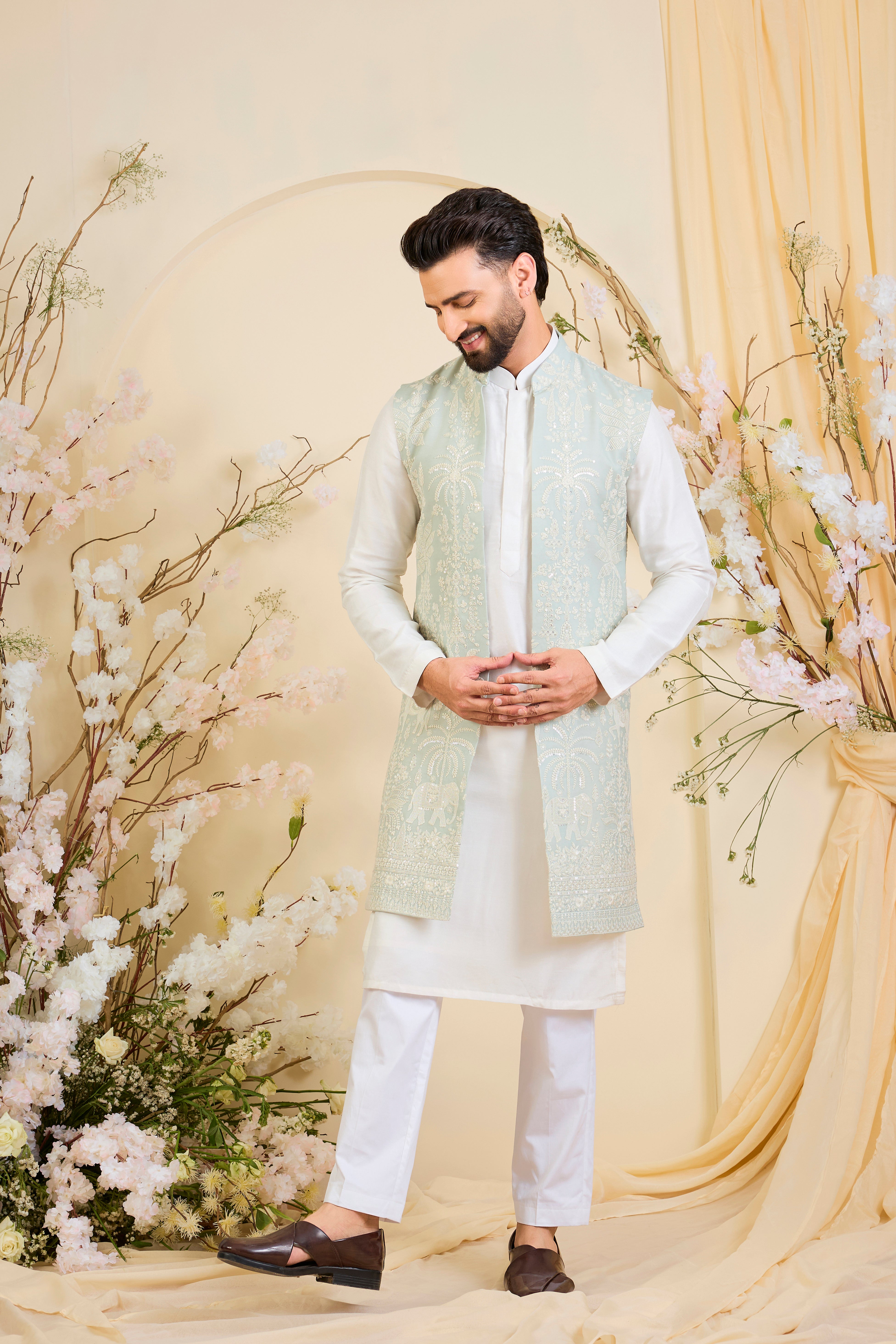 Blue sequined long jacket with ivory threadwork and intricate flora-fauna embroidery, crafted for luminous, refined, statement-making elegance.