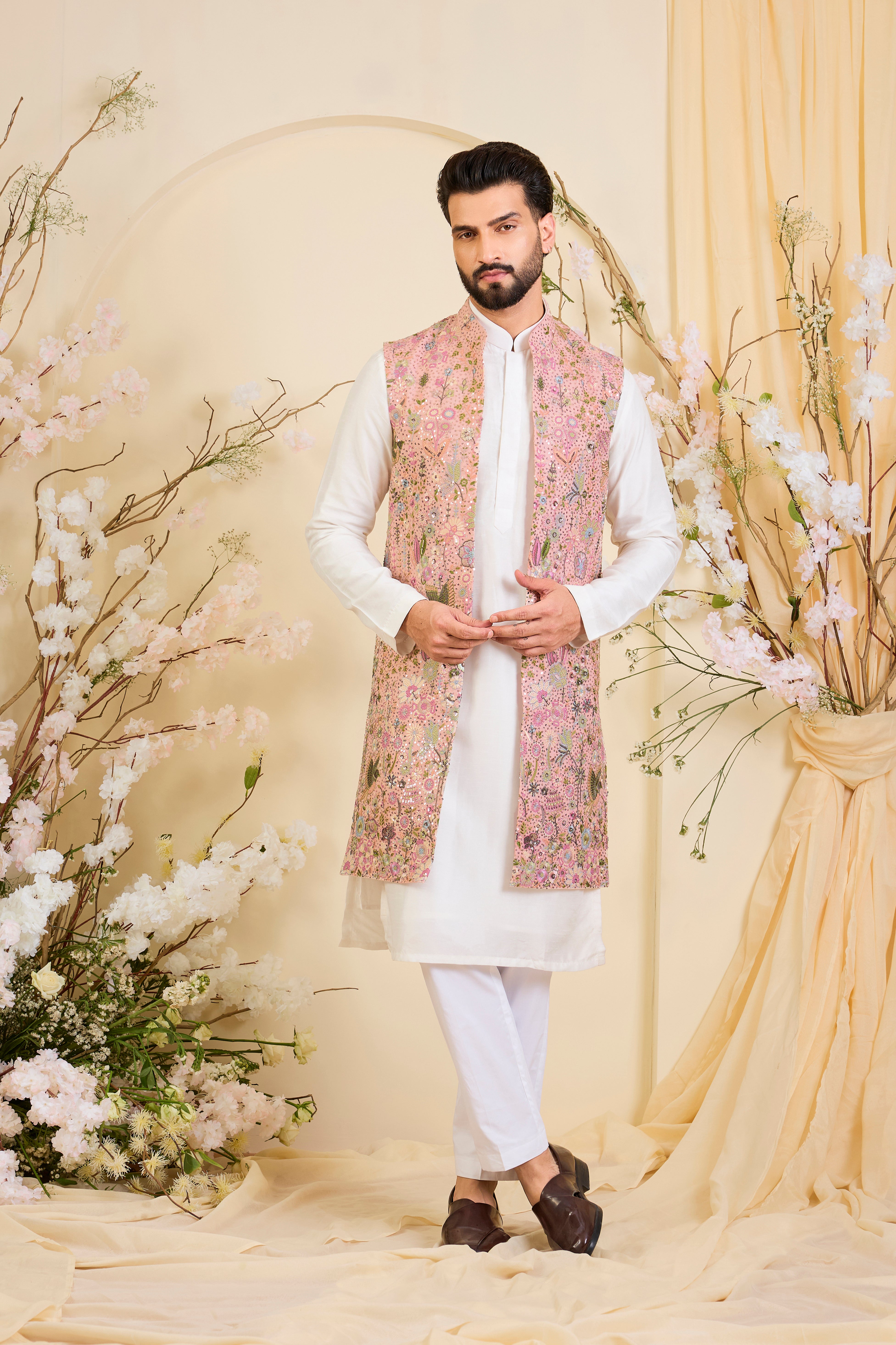 Pink long open jacket with intricate sequin work and detailed flora-fauna motifs, offering a luminous, richly layered couture statement.