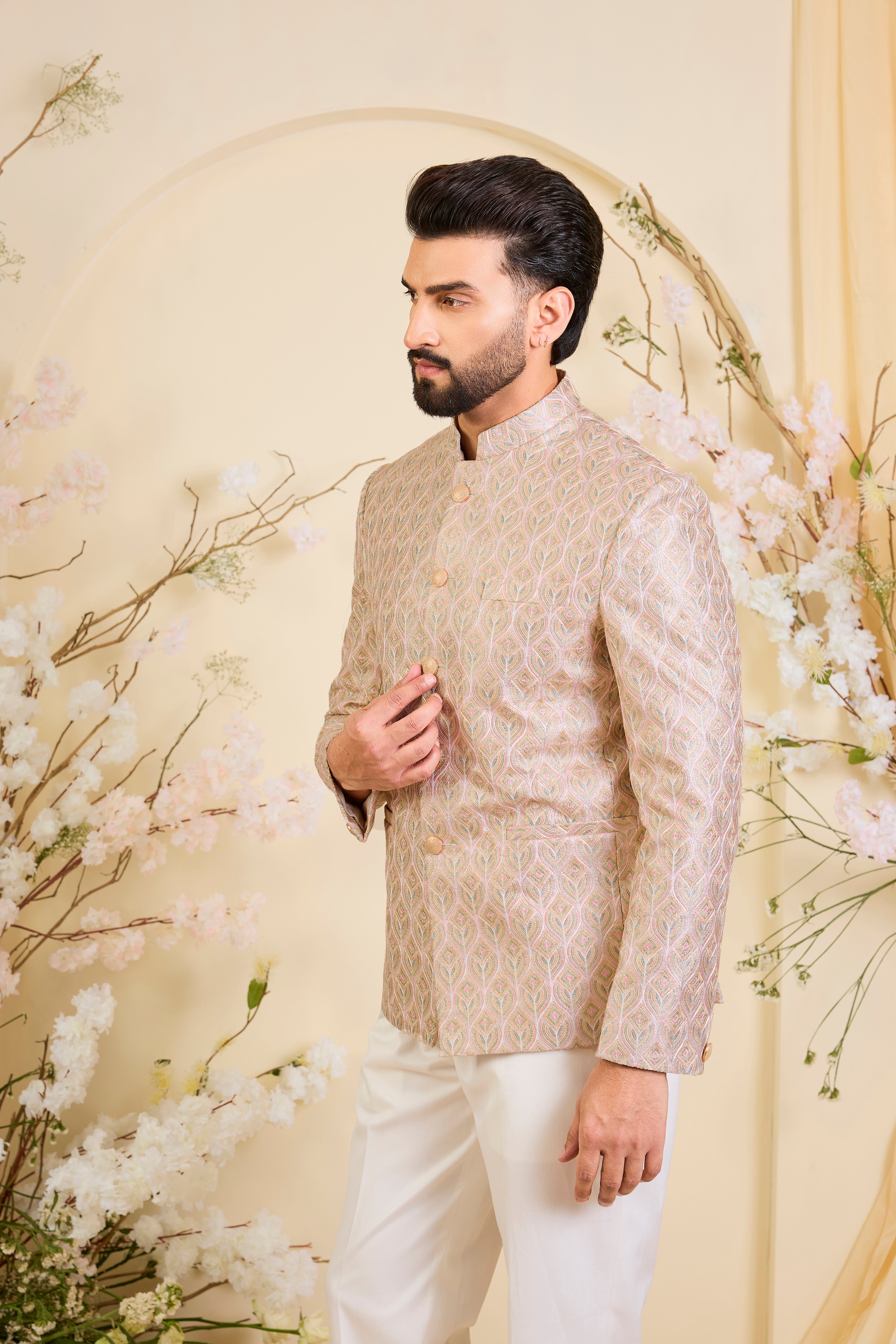 Multicoloured short bandhgala with intricate threadwork and delicate, light-catching zari detailing, offering a bold yet refined couture statement.