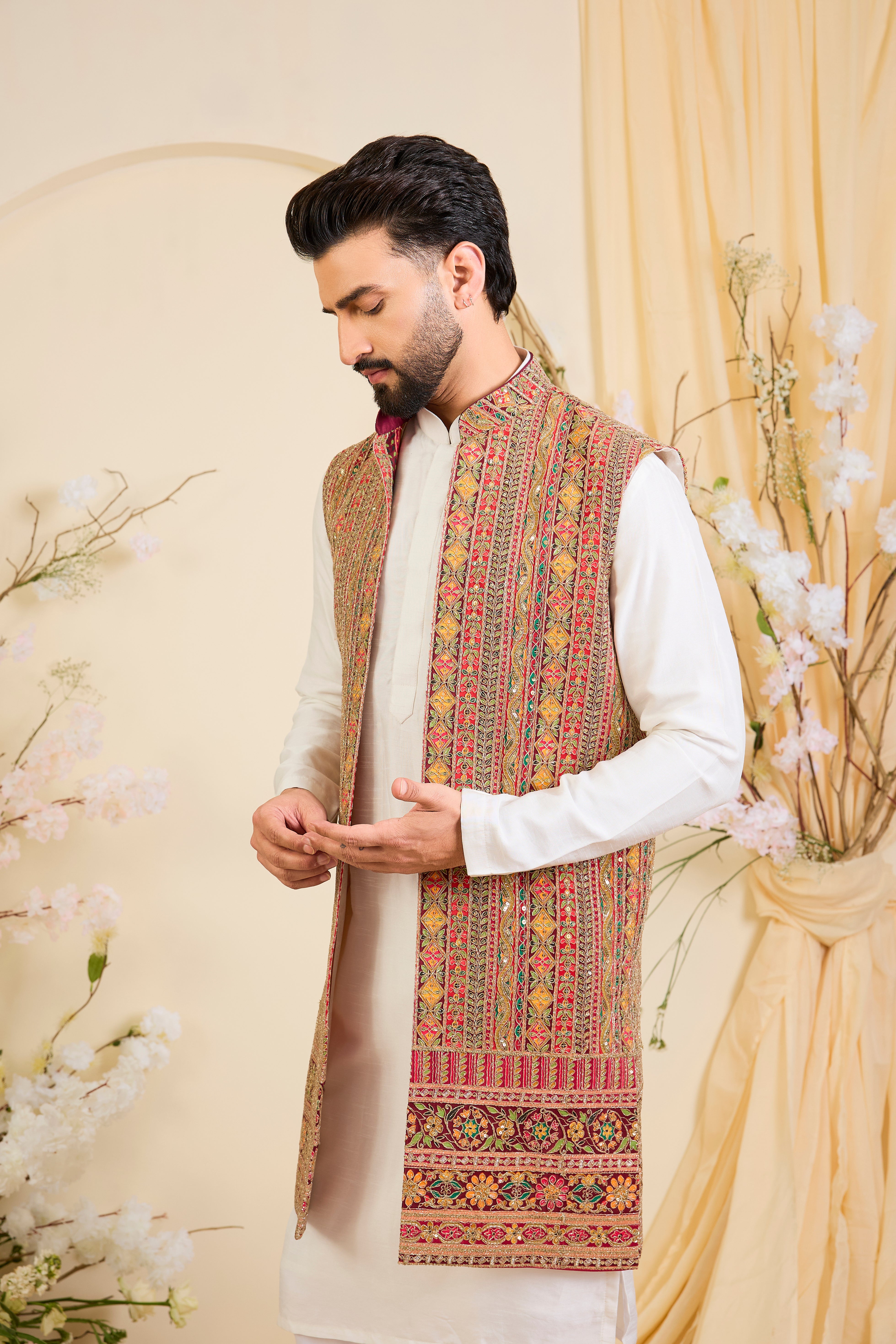 Pink base open long jacket with heavy zari embroidery, intricate sequins, and multicolour prints, crafted for bold, opulent, statement-making occasions.