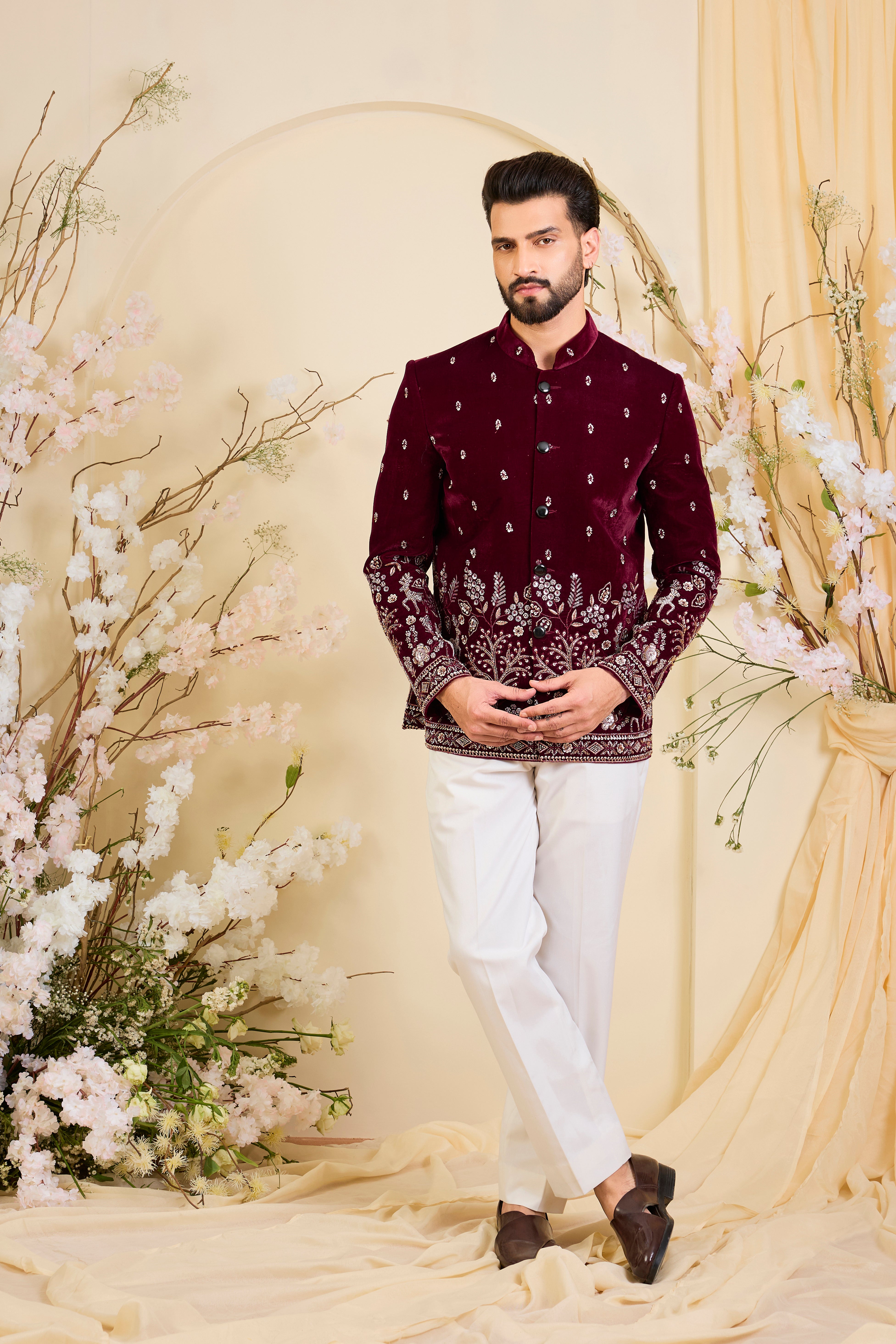 An opulent maroon bandgala , intricately hand-embroidered with dense cut dana work and elaborate flora-fauna motifs, exuding regal depth and grand sophistication.