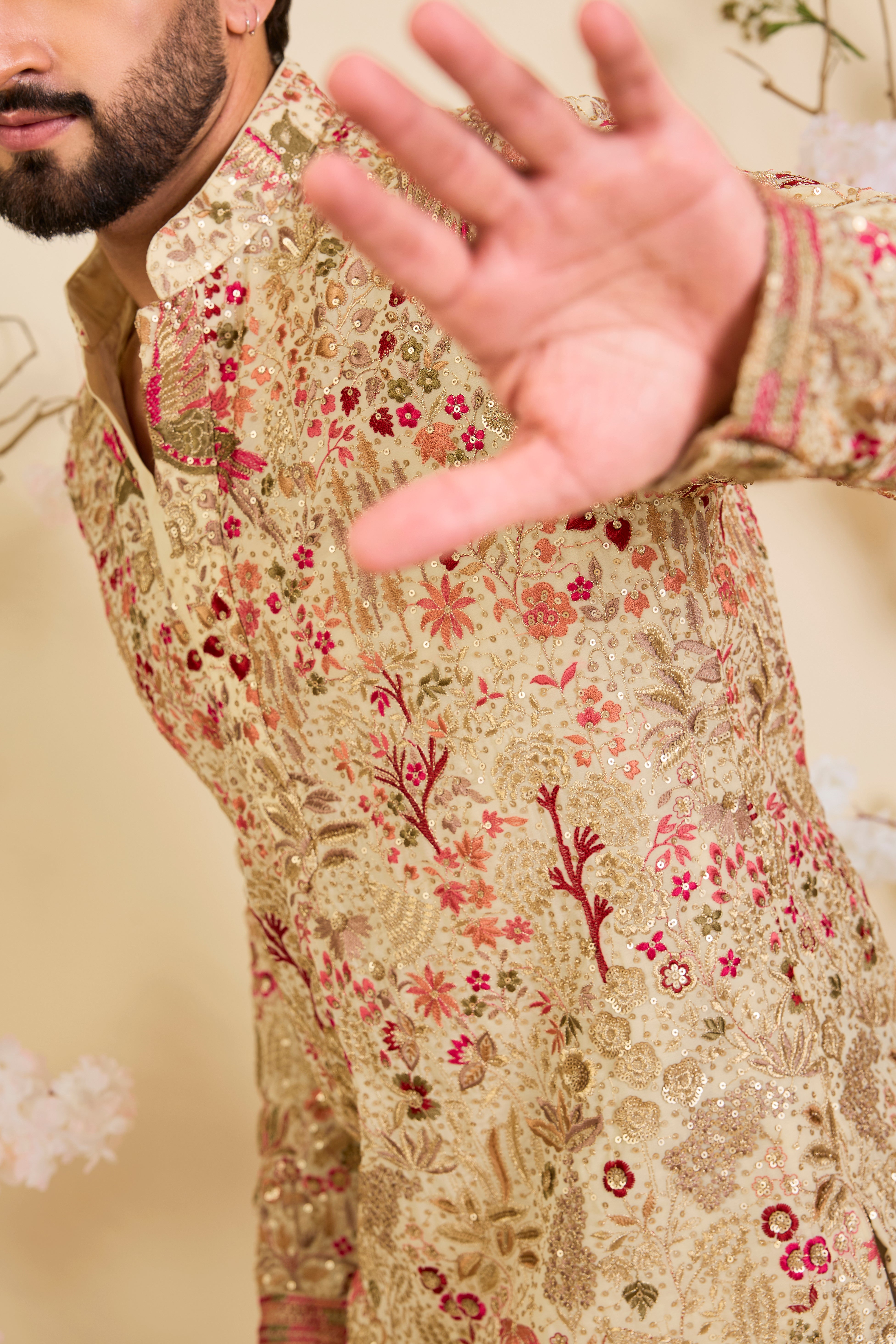 Golden-cream kurta with multicolour threadwork, zari, and sequins, creating a magical flora-fauna canvas with luminous, dreamlike elegance.