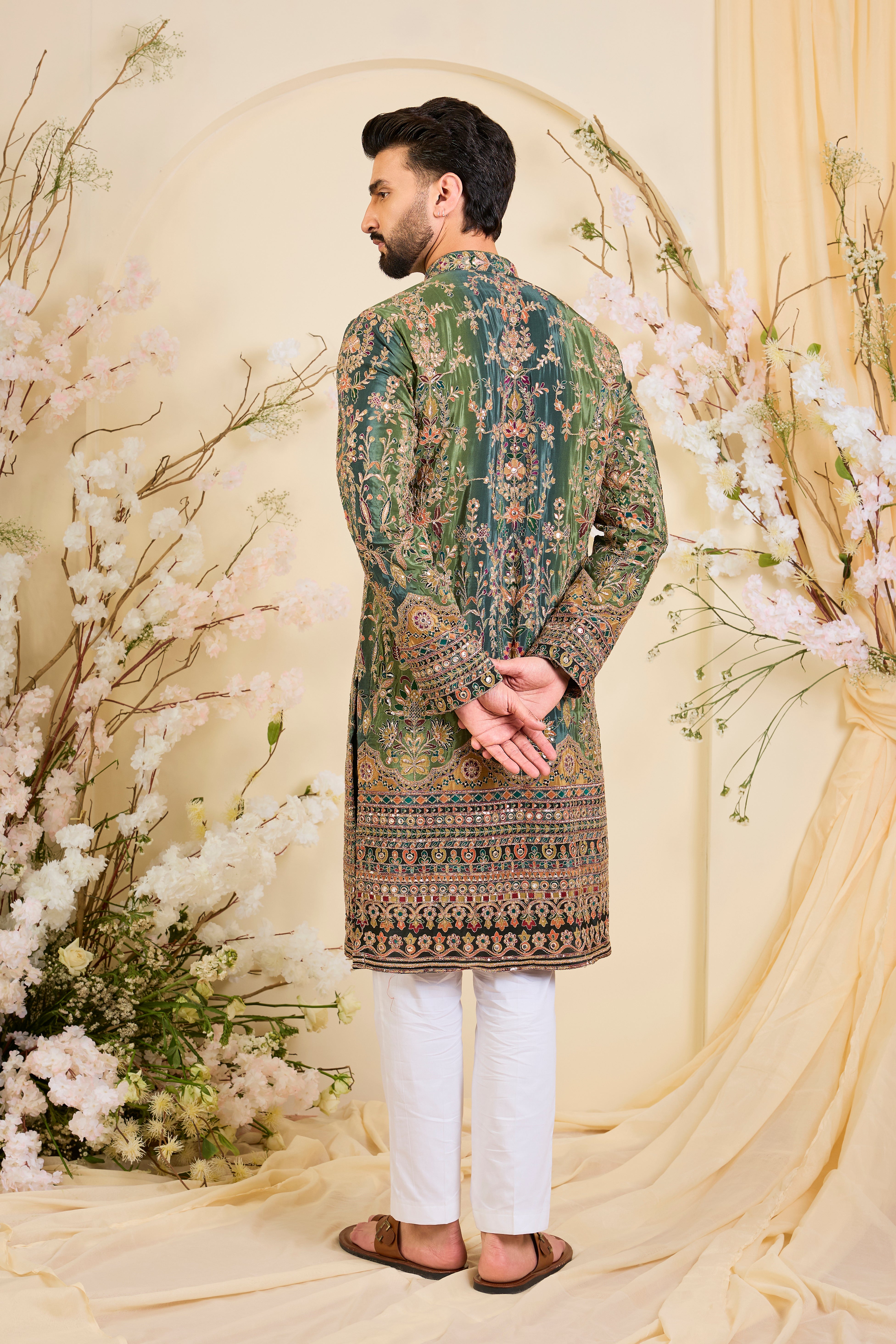 Green crepe  kurta with intricate zari work, vibrant multicolour prints, and refined sequin detailing.