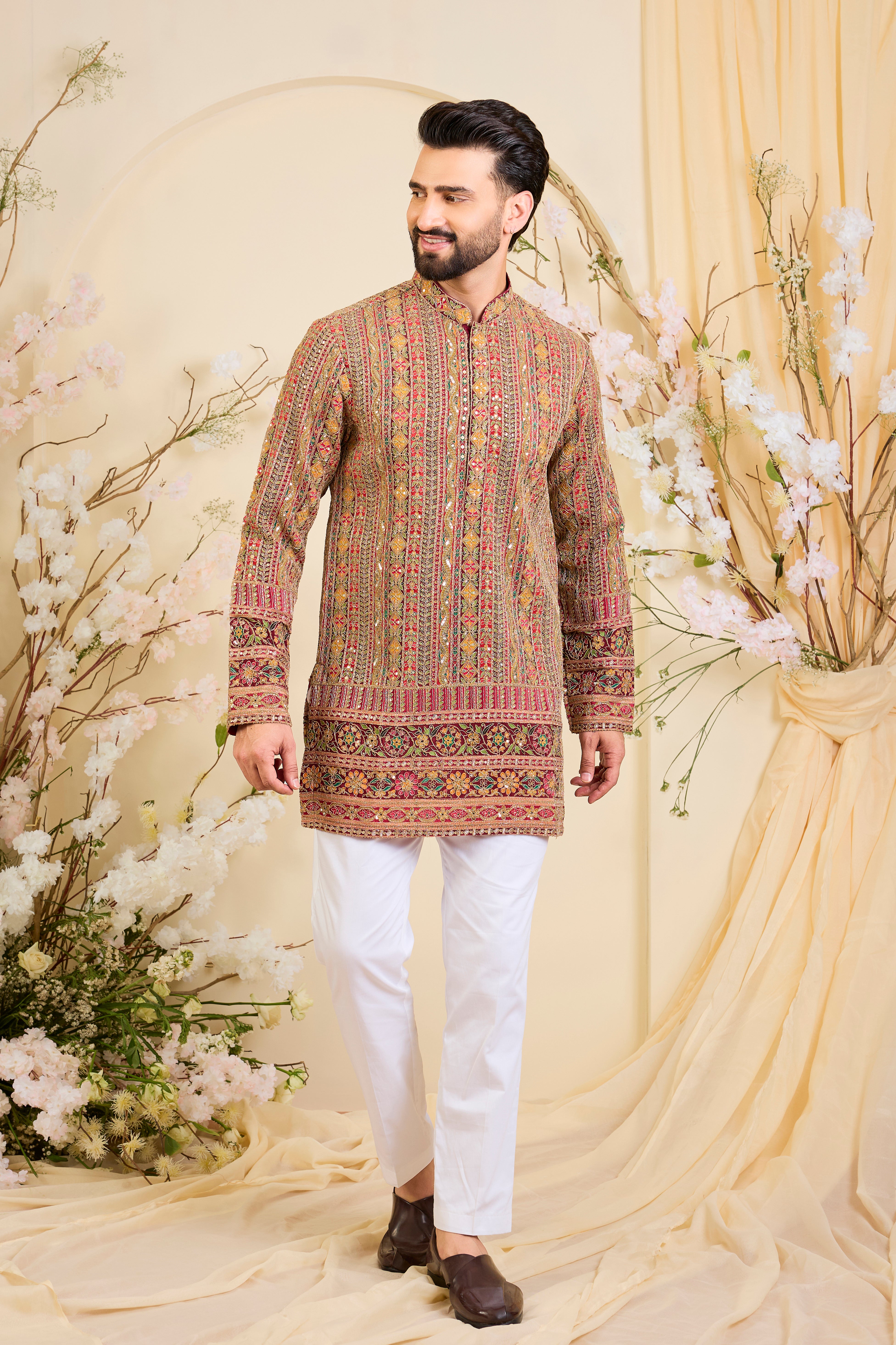 Pink base short kurta with heavy zari embroidery, intricate sequins, and multicolour prints, crafted for bold, opulent, statement-making occasions.