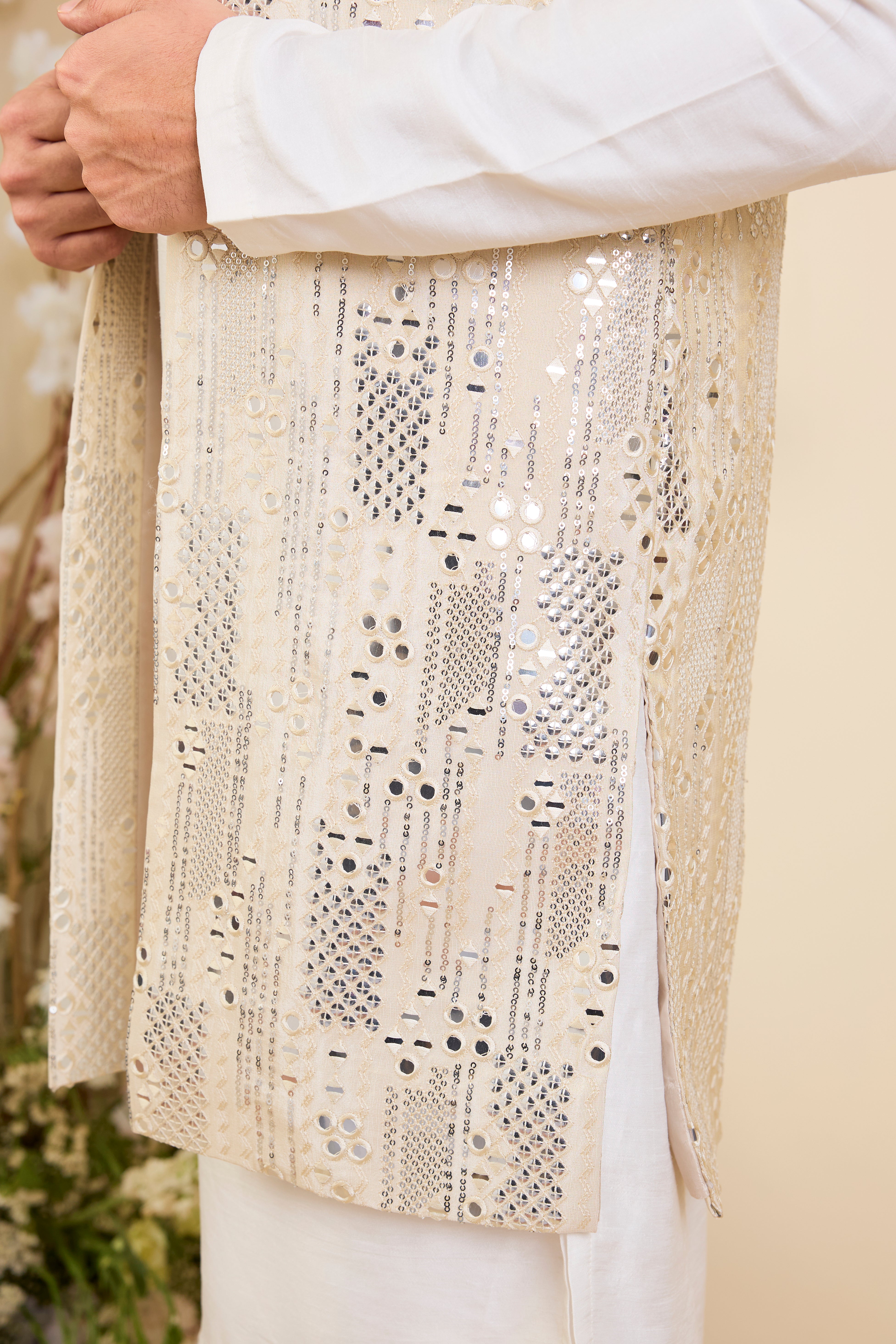 Crafted in luminous tissue, this long open jacket is intricately detailed with sequin mirrorwork, creating a refined illusion of traditional mirrors.