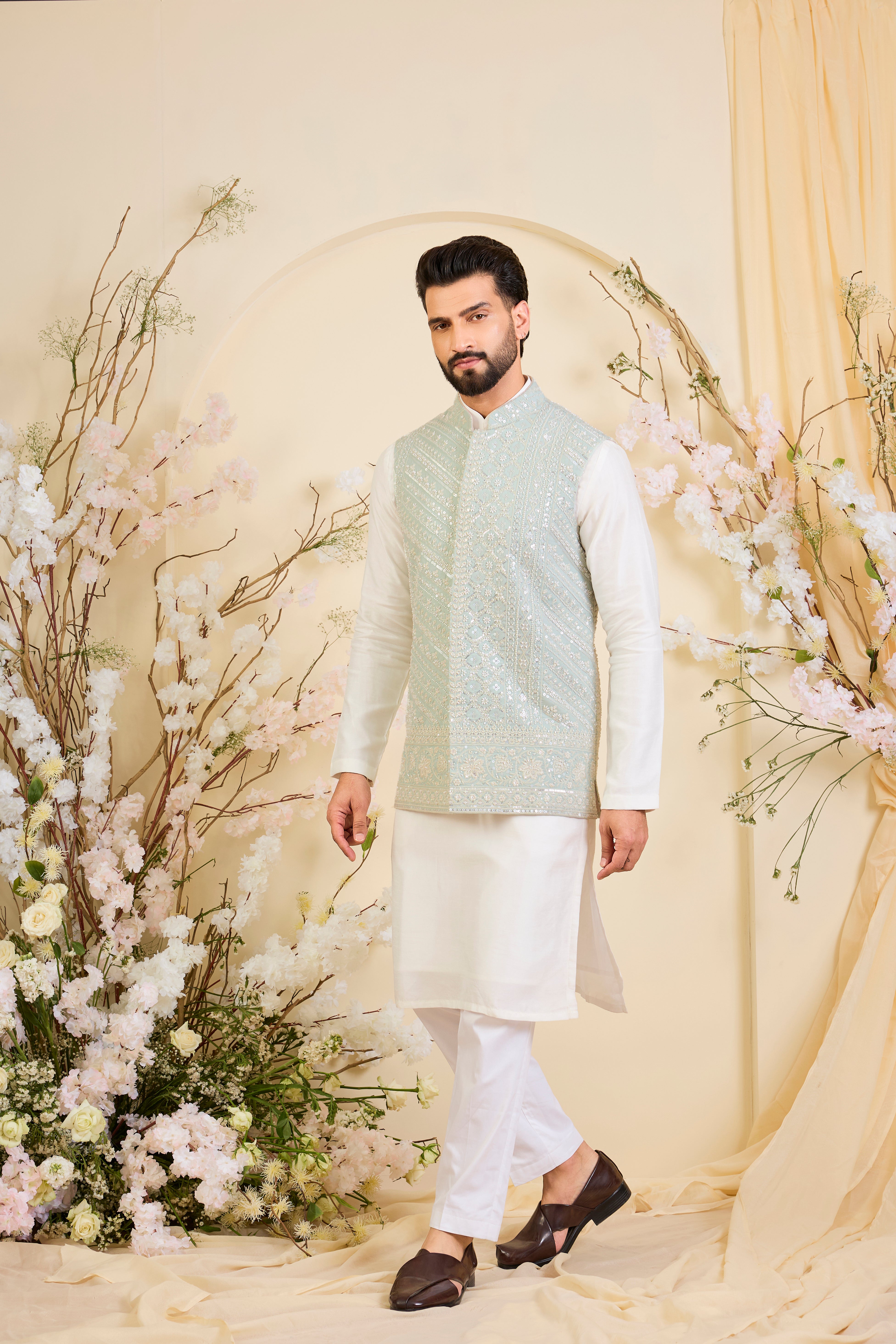 Powder blue Nehru jacket with hand embroidery and delicate ivory cut dana work, offering a soft, luminous, and refined couture expression.