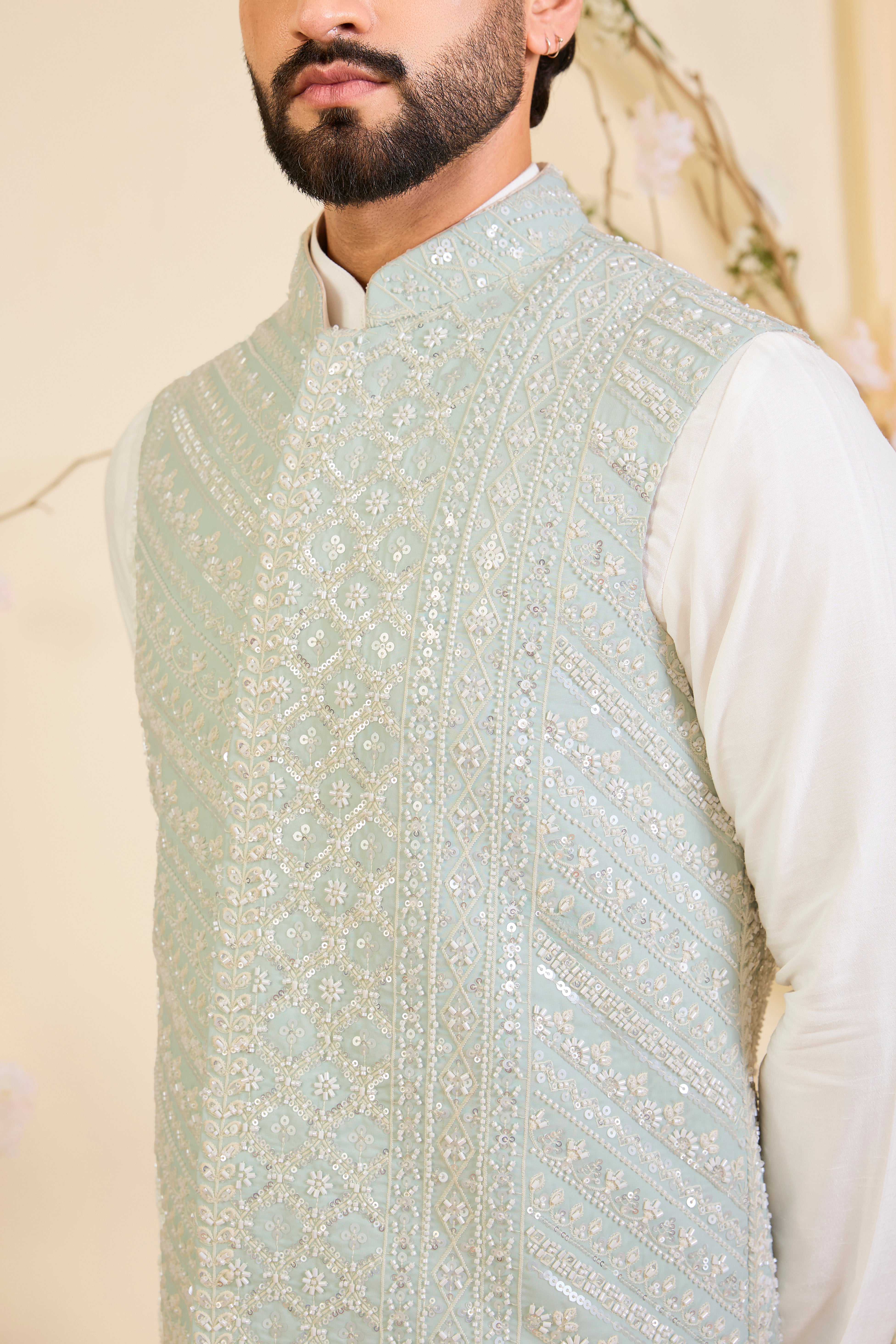 Powder blue Nehru jacket with hand embroidery and delicate ivory cut dana work, offering a soft, luminous, and refined couture expression.