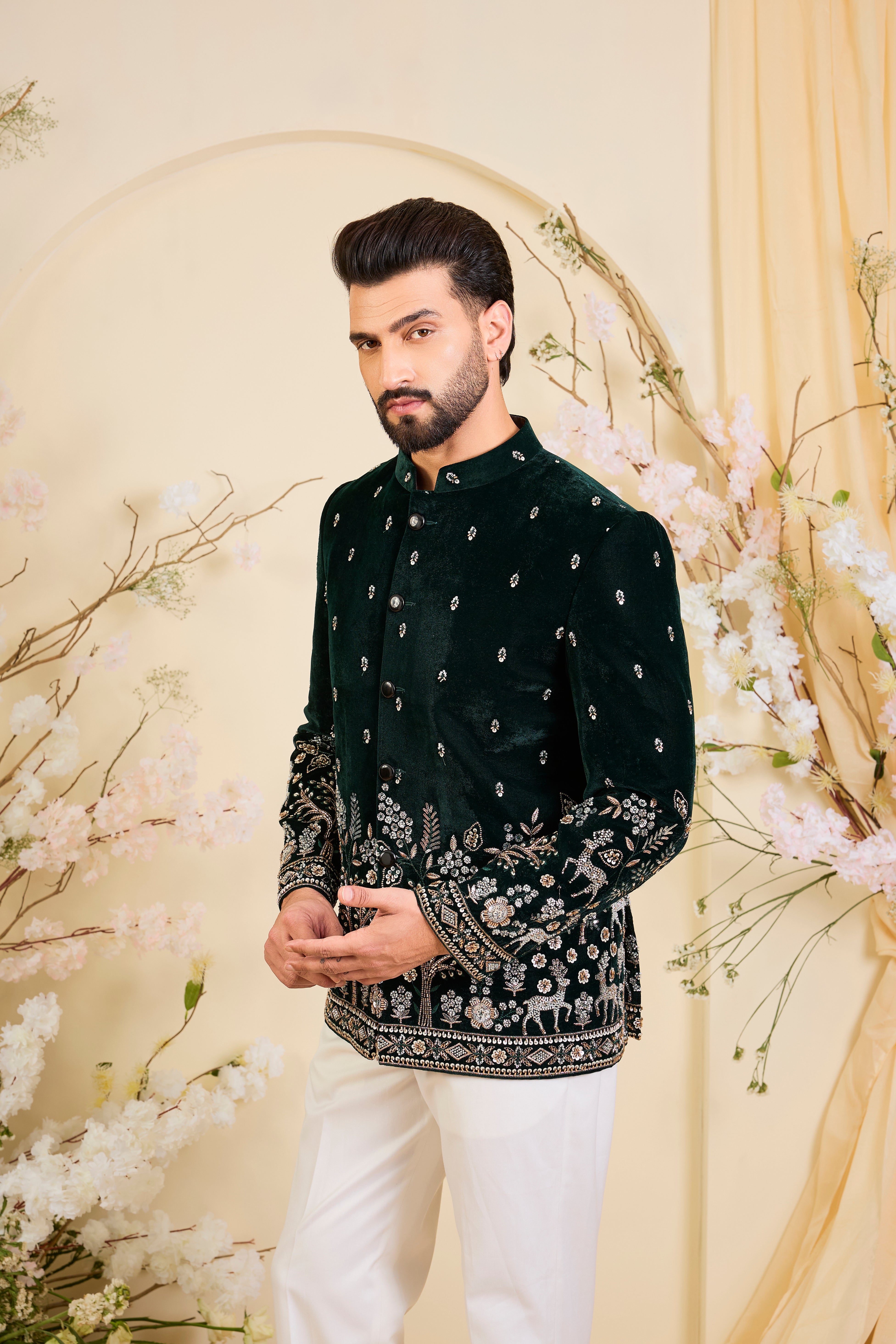 An opulent bottle green bandgala , intricately hand-embroidered with dense cut dana work and elaborate flora-fauna motifs, exuding regal depth and grand sophistication.