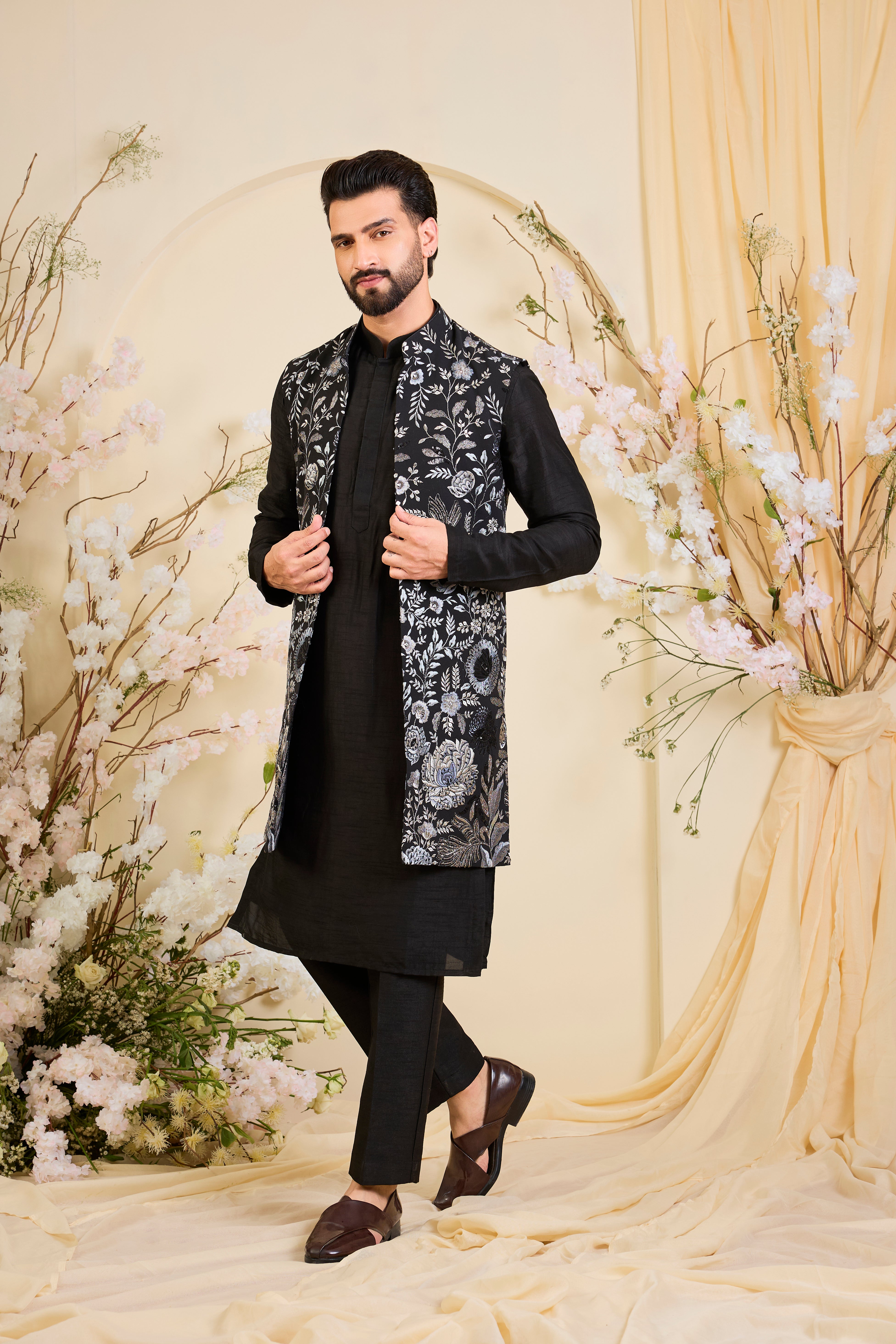 Black long open jacket with intricate floral patterns in grey-blue threadwork, elevated by detailed sequin embellishments for a refined, statement look.