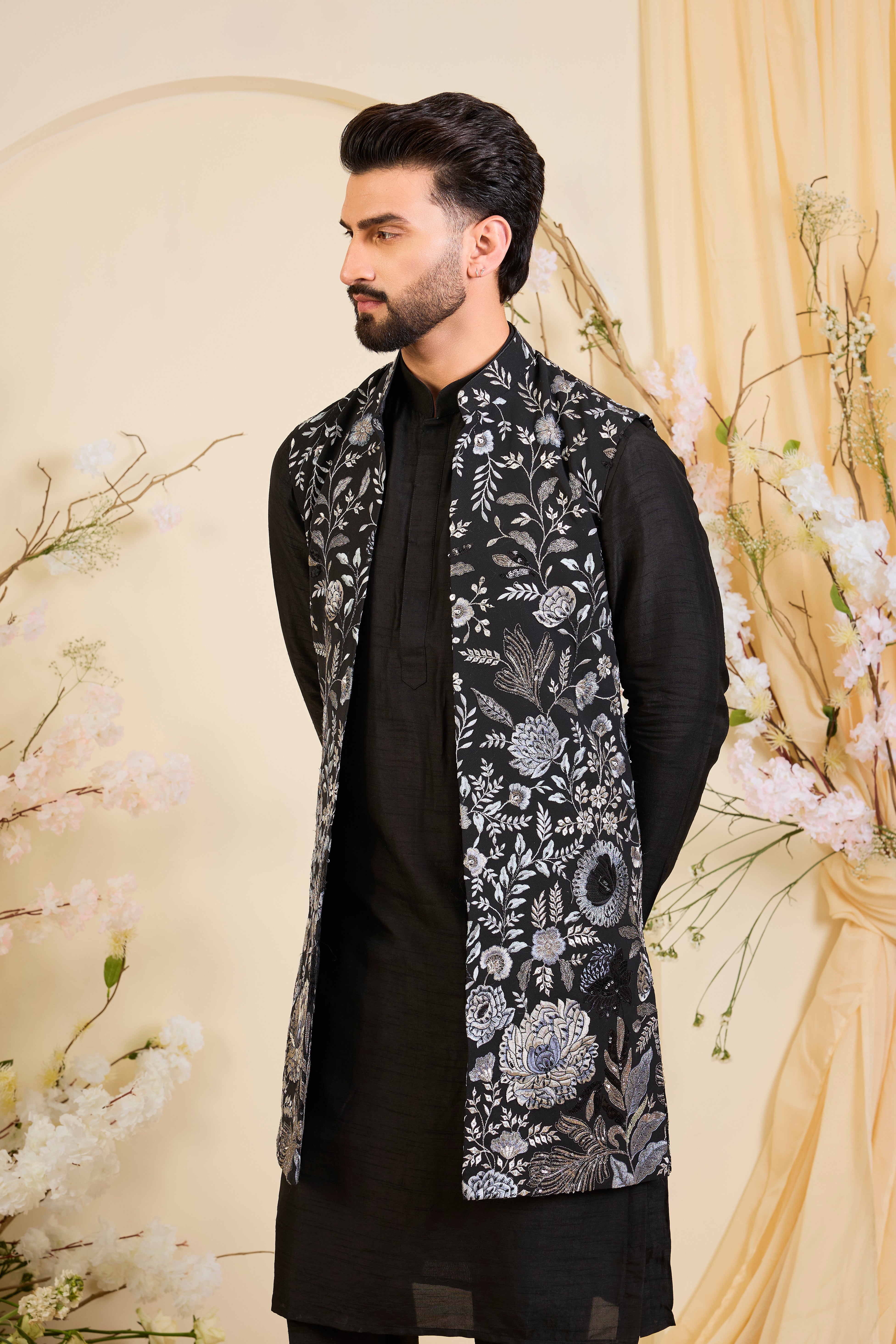 Black long open jacket with intricate floral patterns in grey-blue threadwork, elevated by detailed sequin embellishments for a refined, statement look.