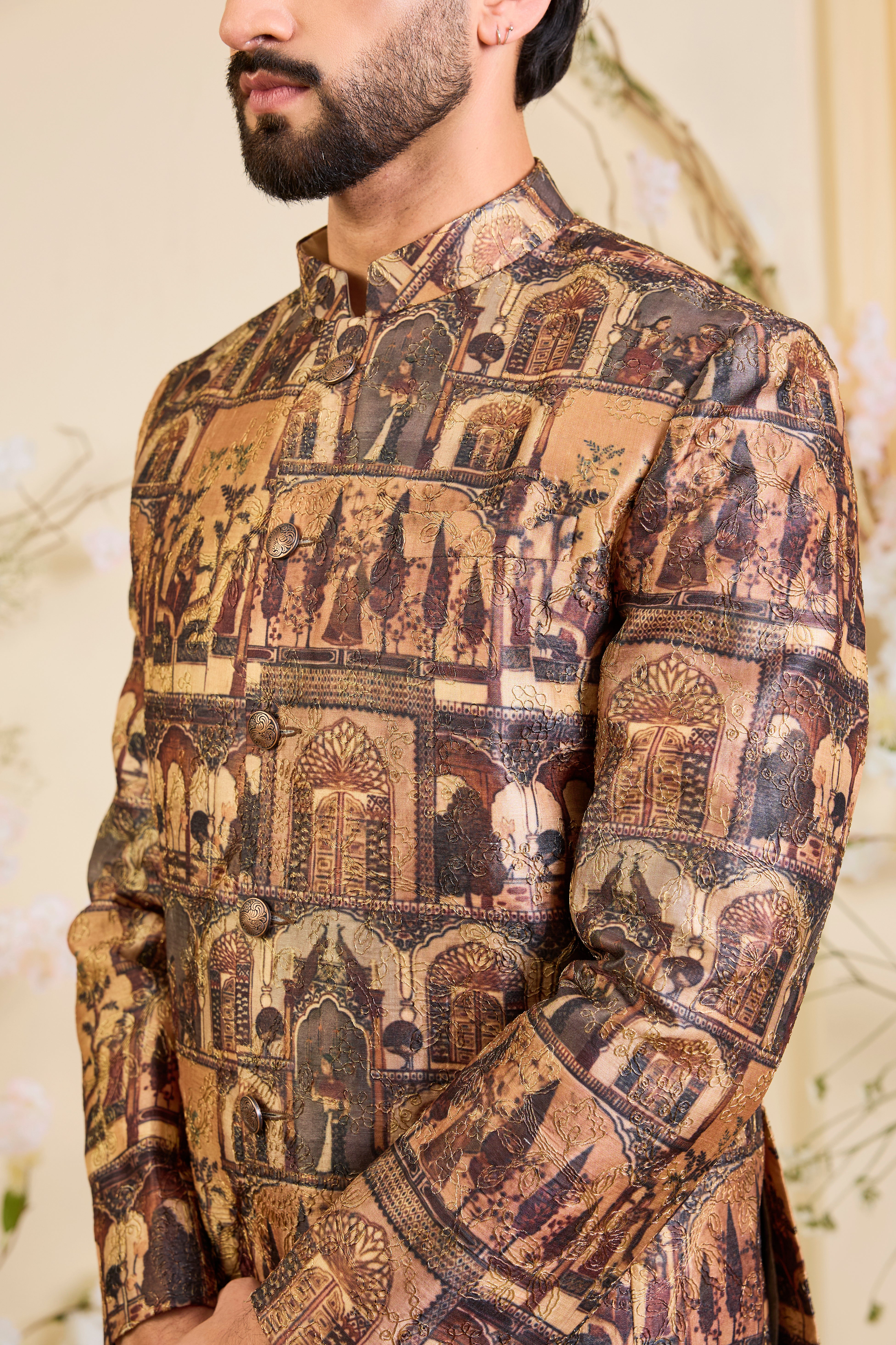 Rendered in a deep earthy brown, this bandgala unfolds like a living canvas of Mughal grandeur, adorned with intricately illustrated royal figures and courtly scenes.