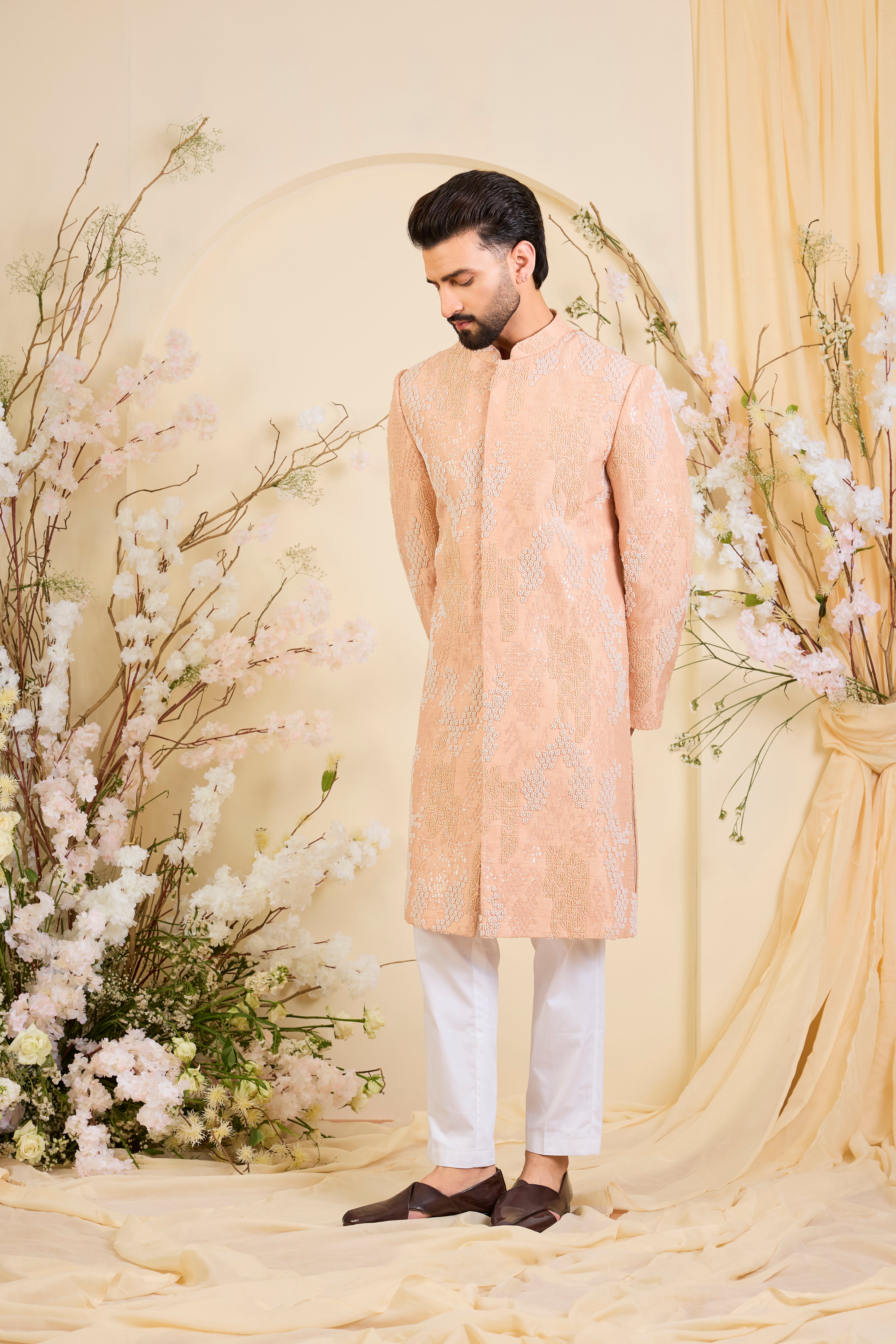 Peach hand-embroidered sherwani with tonal peach and ivory cut dana work, offering a refined, luminous, and impeccably formal couture statement.