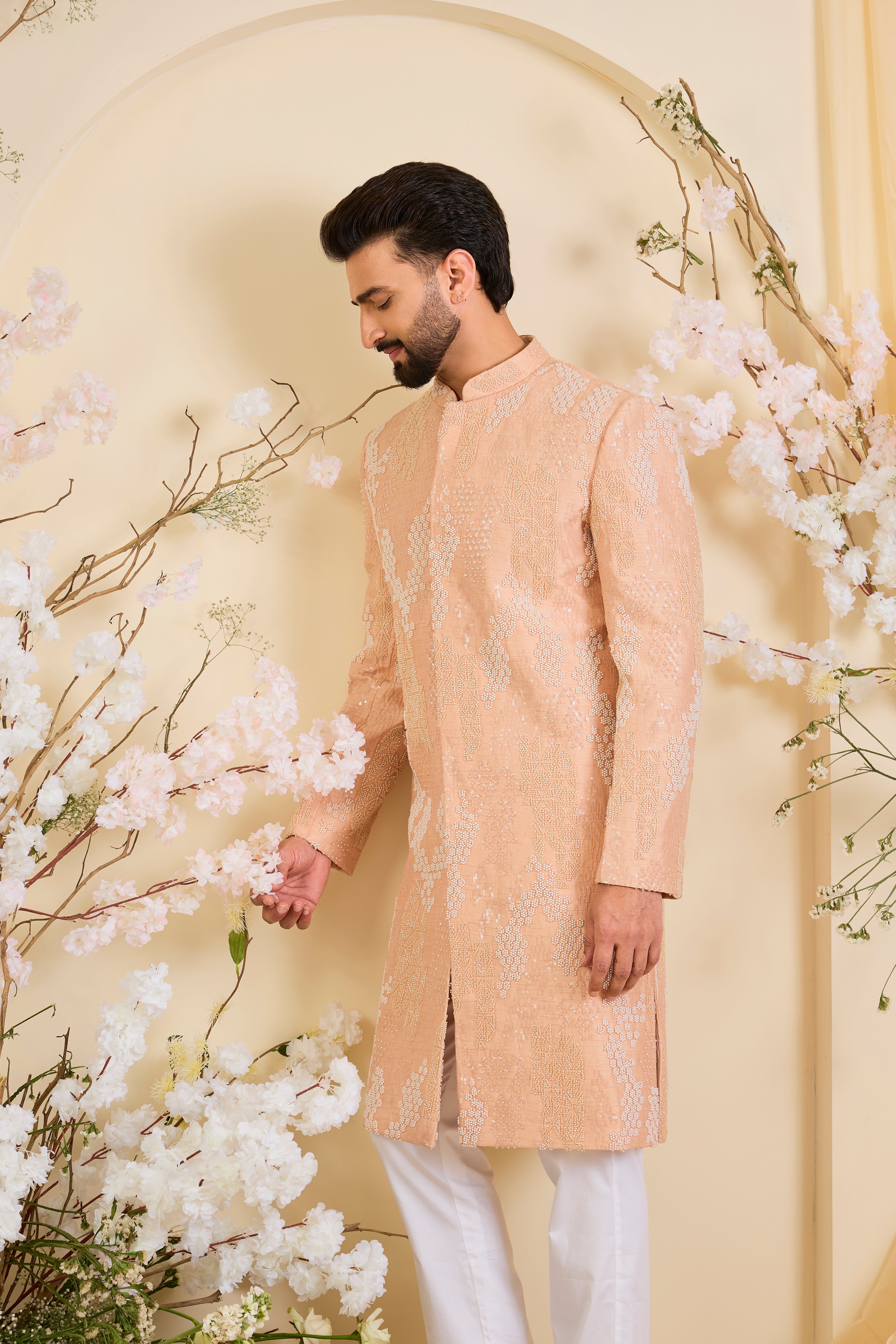 Peach hand-embroidered sherwani with tonal peach and ivory cut dana work, offering a refined, luminous, and impeccably formal couture statement.