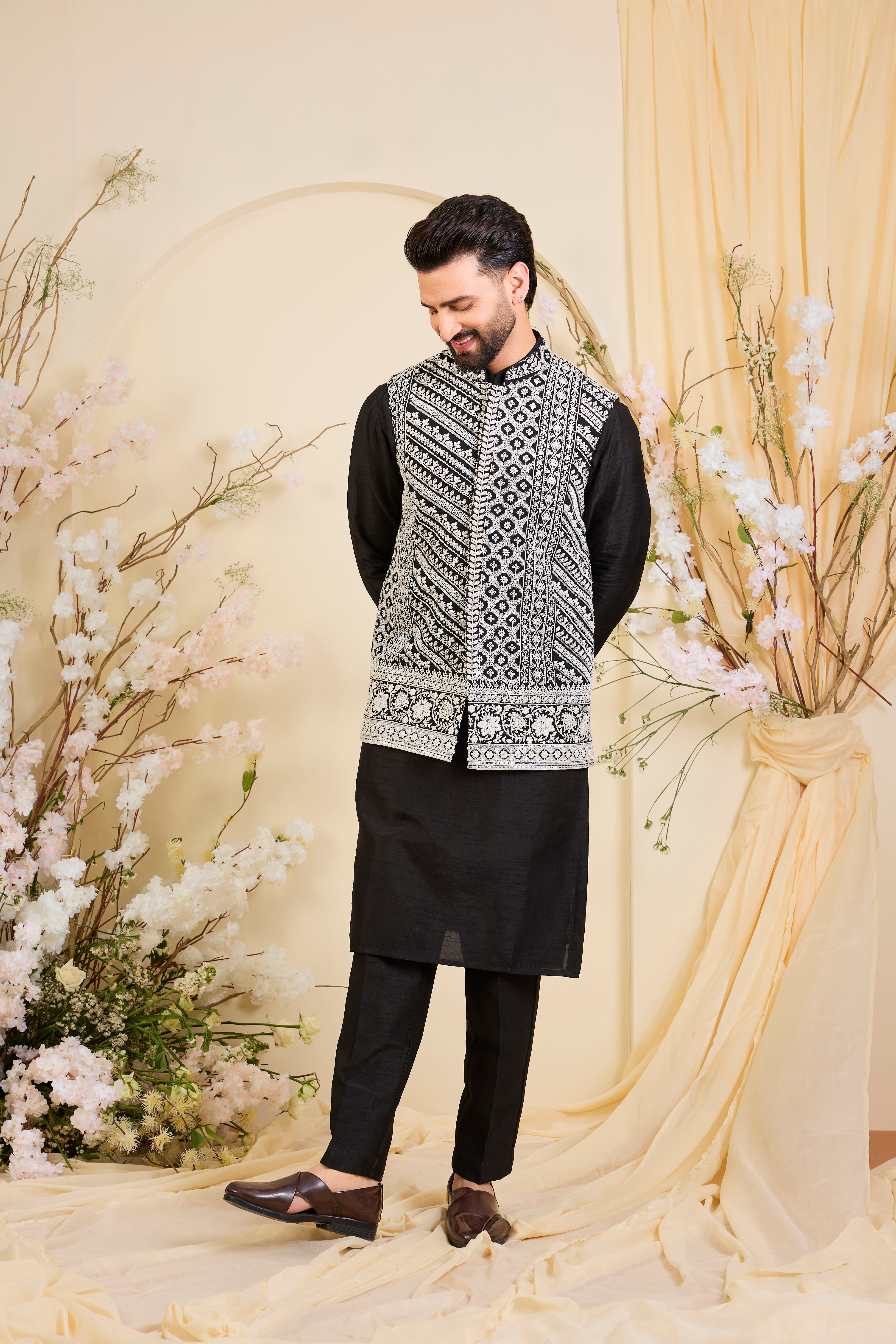 Black Nehru jacket with hand embroidery and delicate ivory cut dana work, offering a luminous, and refined couture expression.