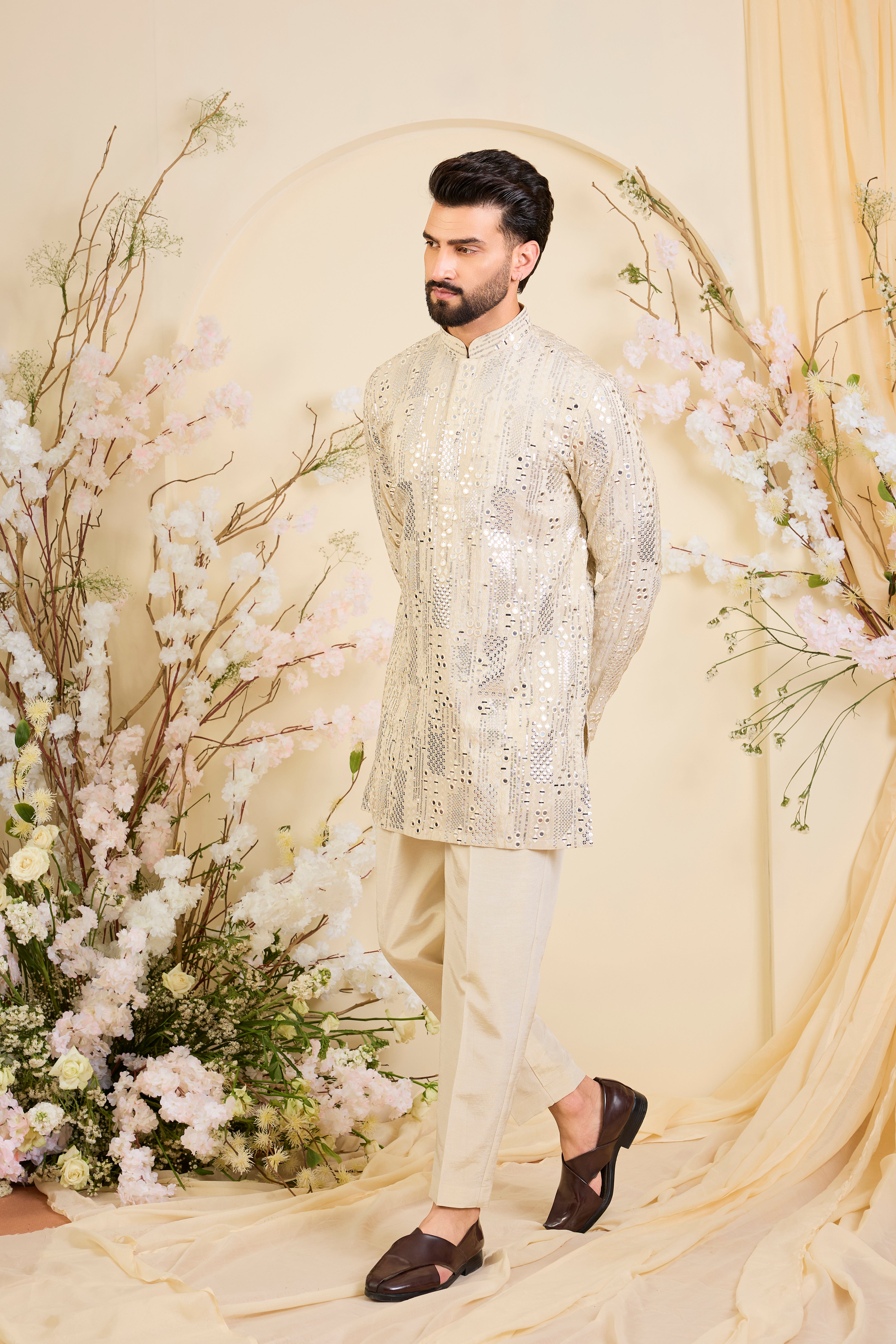 Crafted in luminous tissue, this golden short kurta is intricately detailed with sequin mirrorwork, creating a refined illusion of traditional mirrors.