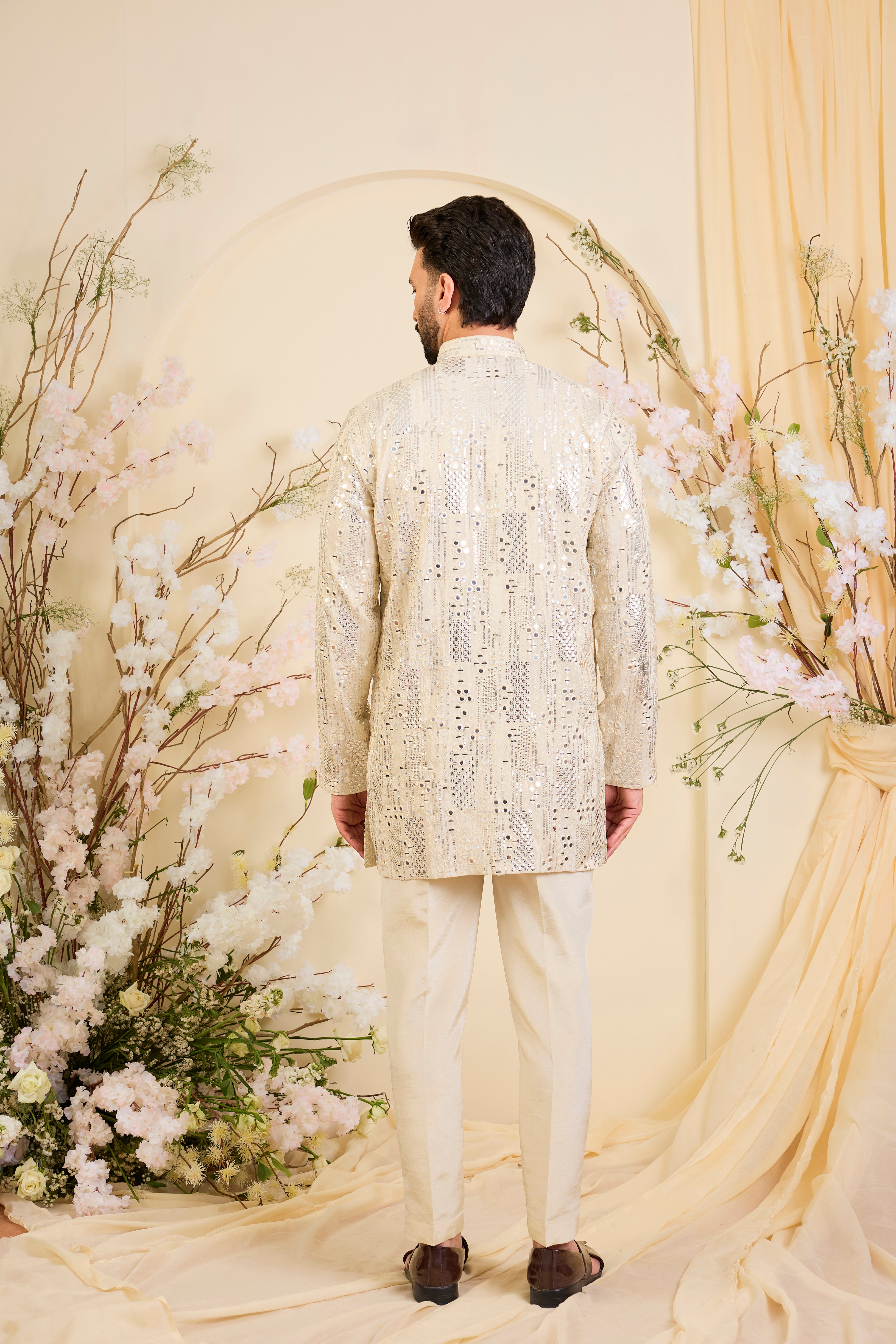 Crafted in luminous tissue, this golden short kurta is intricately detailed with sequin mirrorwork, creating a refined illusion of traditional mirrors.