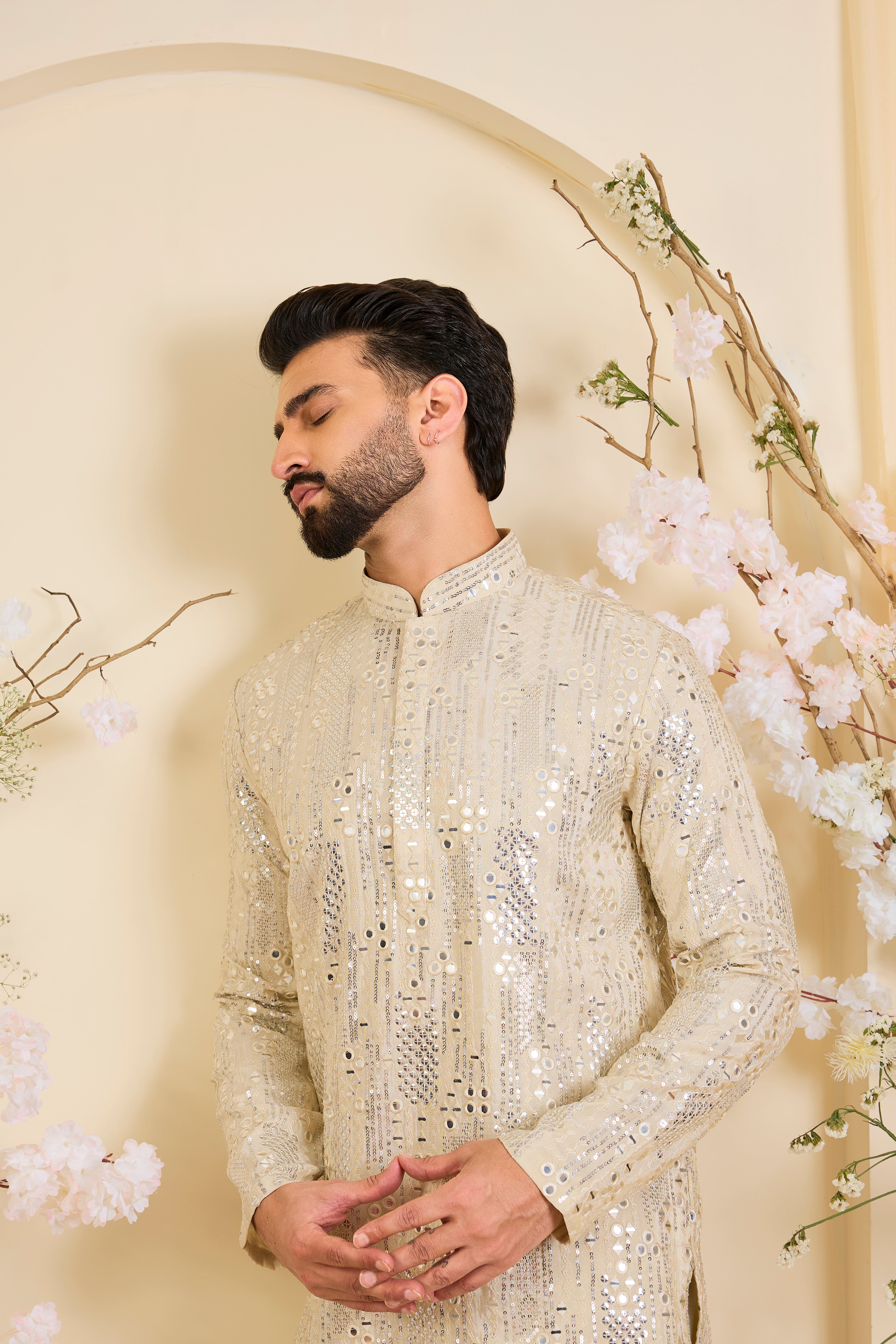 Crafted in luminous tissue, this golden short kurta is intricately detailed with sequin mirrorwork, creating a refined illusion of traditional mirrors.
