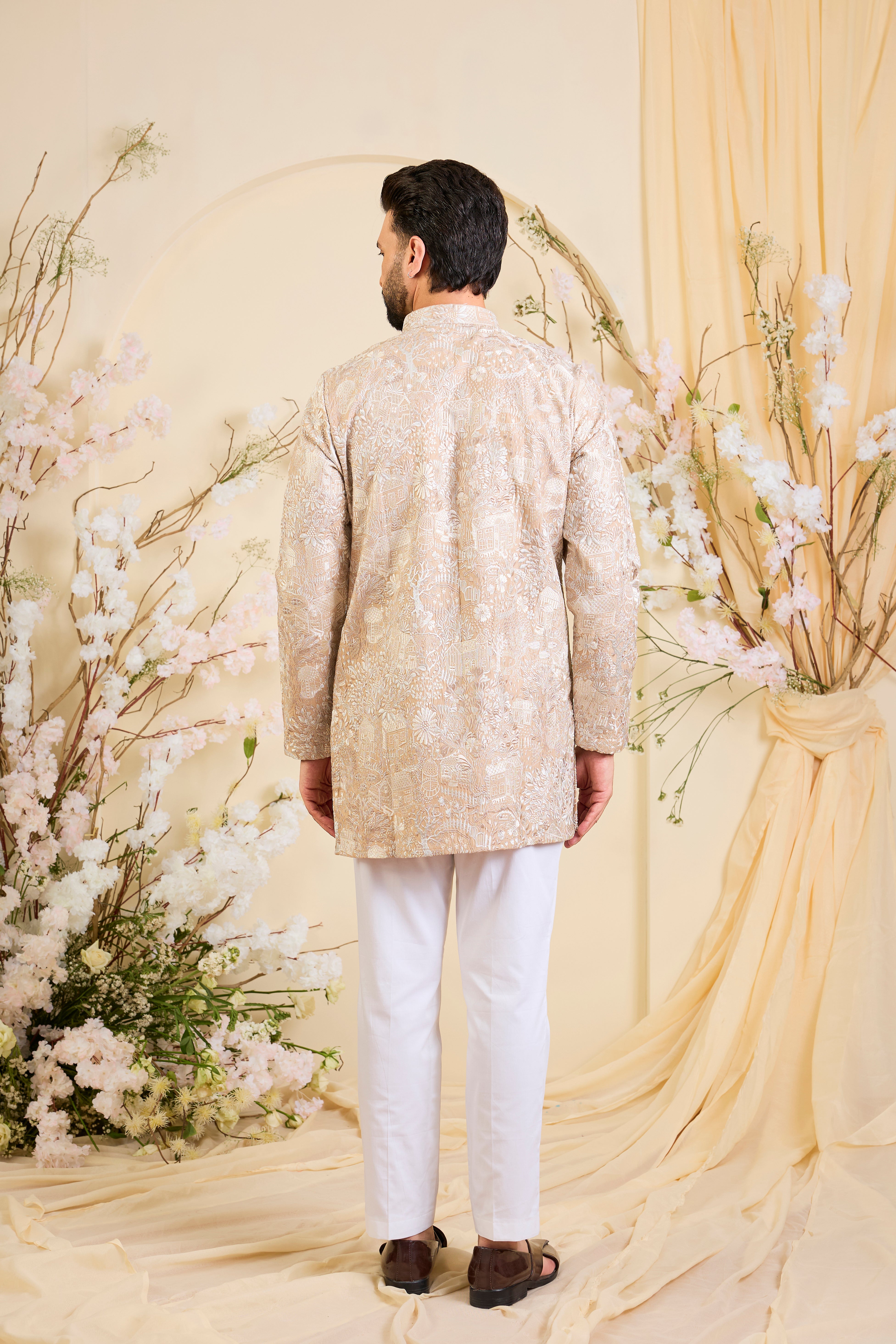Dark beige/ dust pink short kurta with intricate flora-fauna embroidery and dense threadwork, offering a refined, richly textured couture statement.