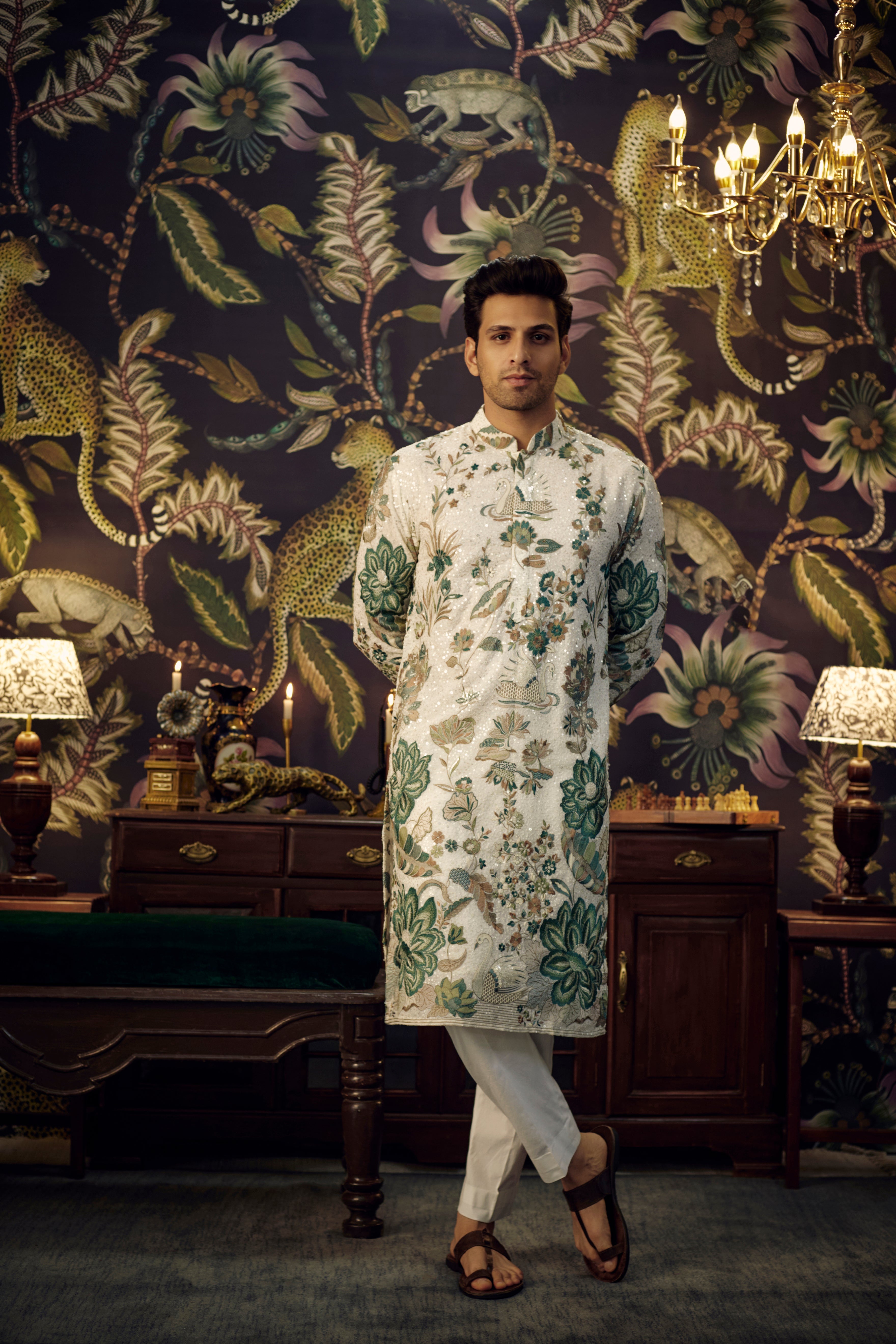 White and green sequined kurta showcasing detailed flora and fauna motif. - kasbahmen