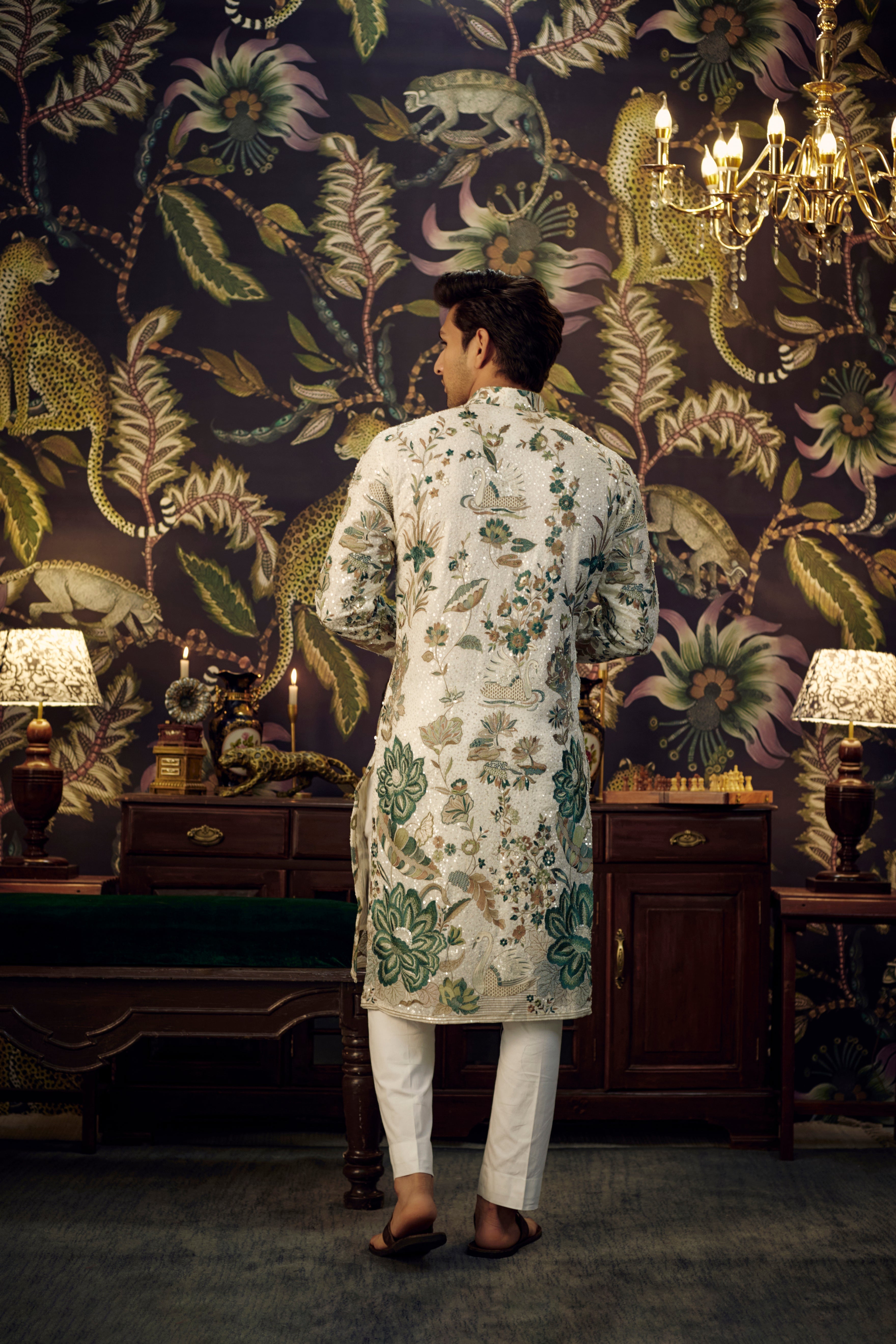 White and green sequined kurta showcasing detailed flora and fauna motif. - kasbahmen