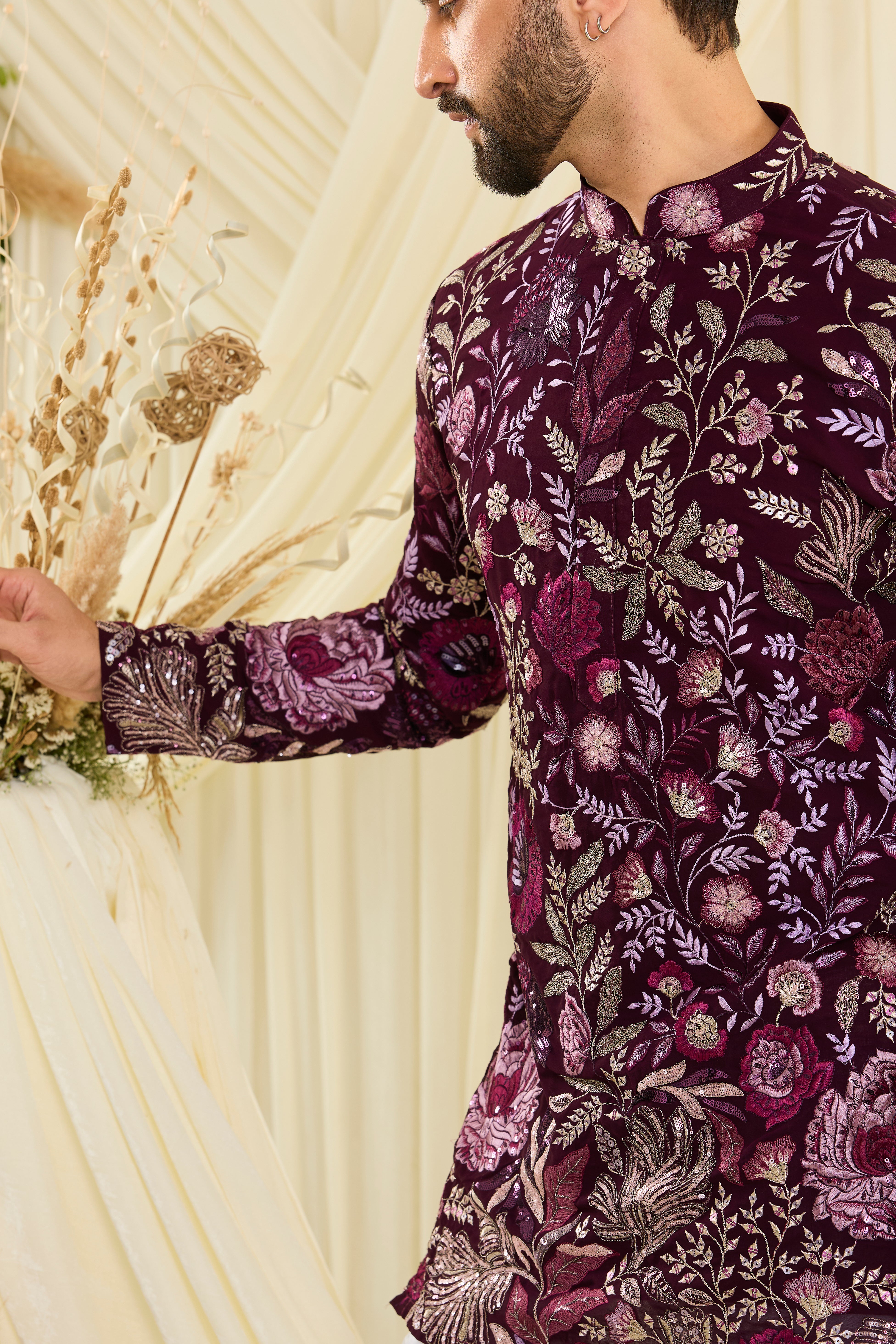 Wine-purple short kurta featuring detailed floral embroidery, delicate zari work, and sequins for a sharp, luxe festive vibe.