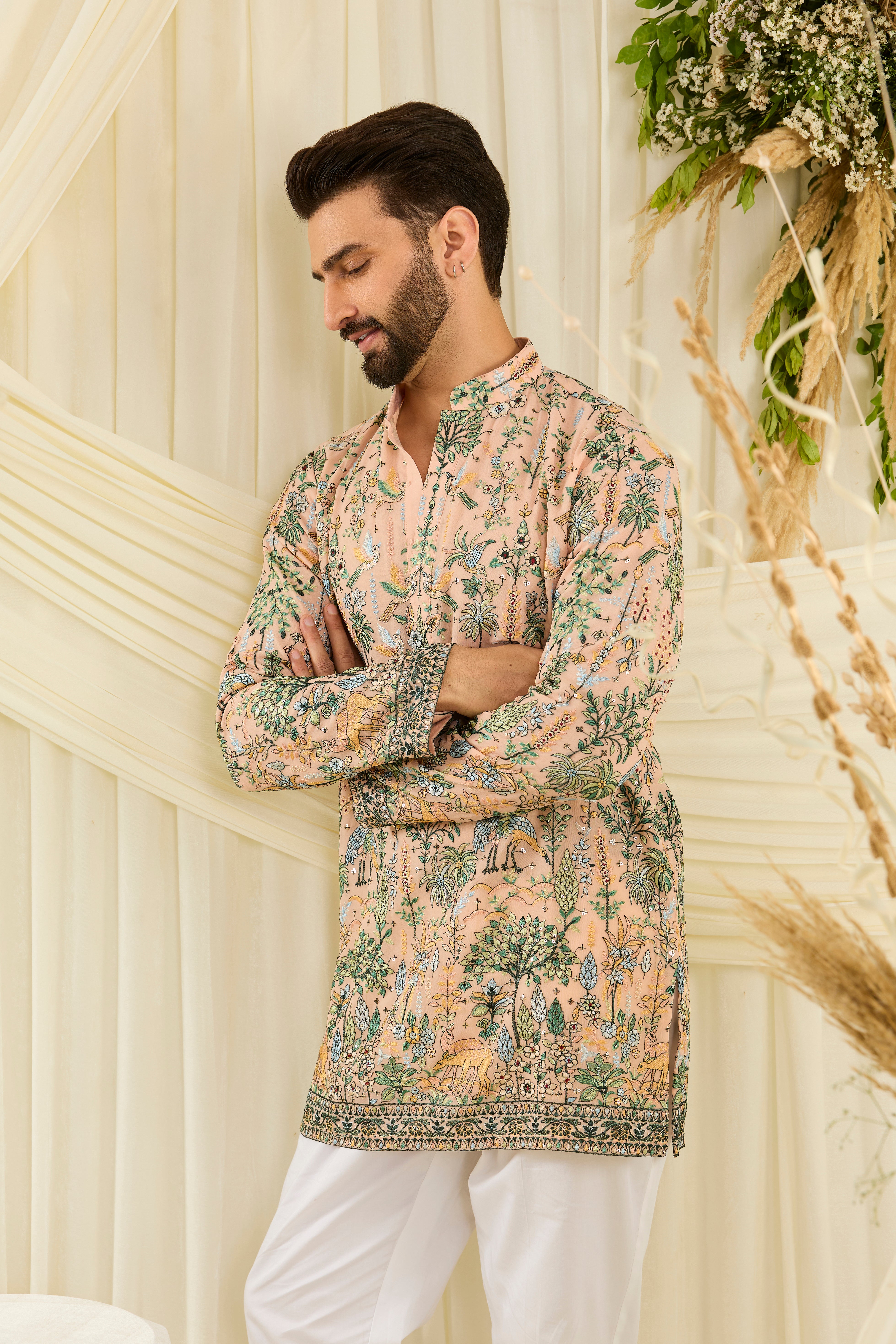 Peach short kurta with intricate flora-fauna embroidery, multicolour threadwork, and delicate sequins for a fresh, luxe festive statement.