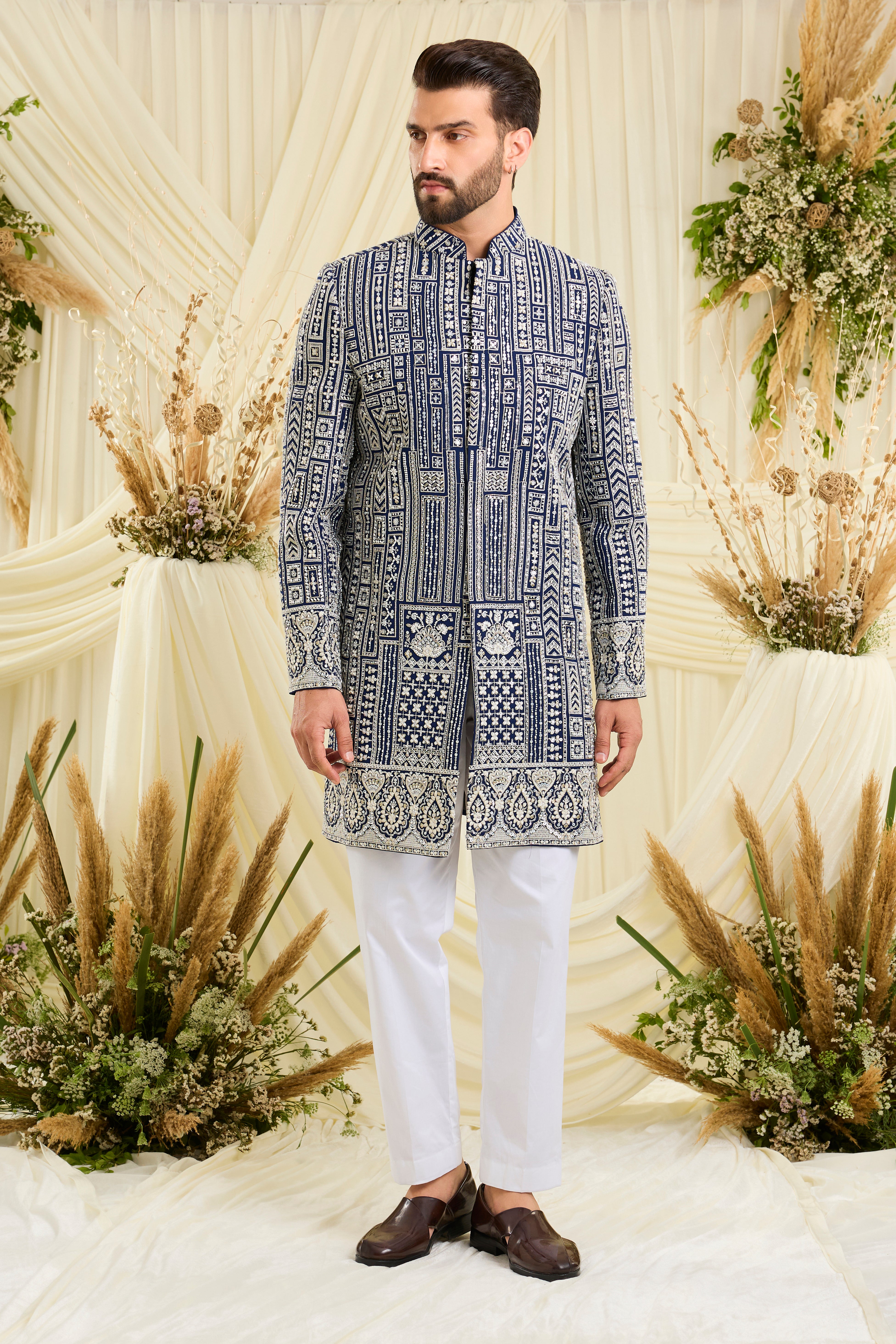 Royal blue short sherwani with intricate white cut dana work and delicate sequins, crafted for a bold, ultra-luxurious statement.