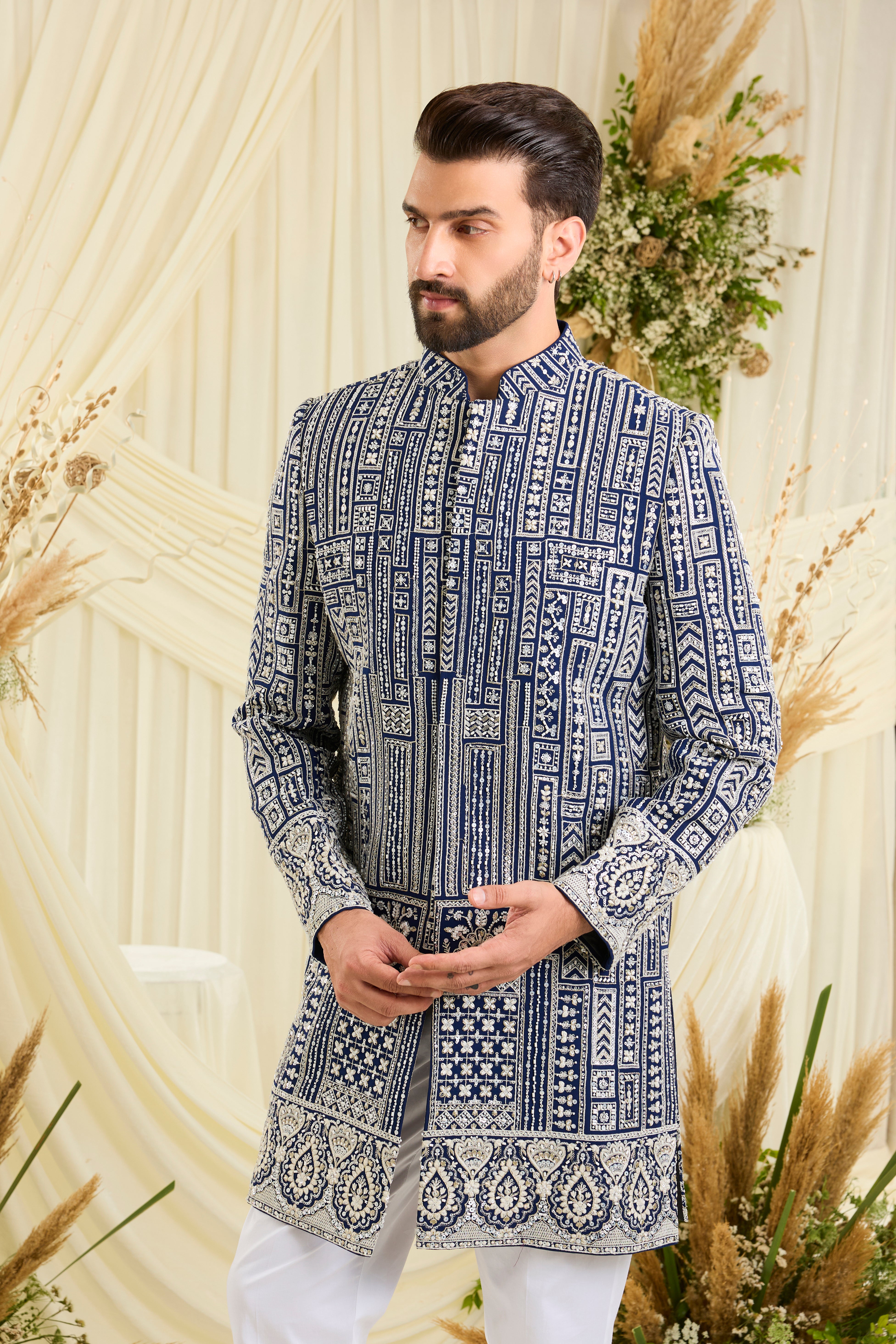 Royal blue short sherwani with intricate white cut dana work and delicate sequins, crafted for a bold, ultra-luxurious statement.