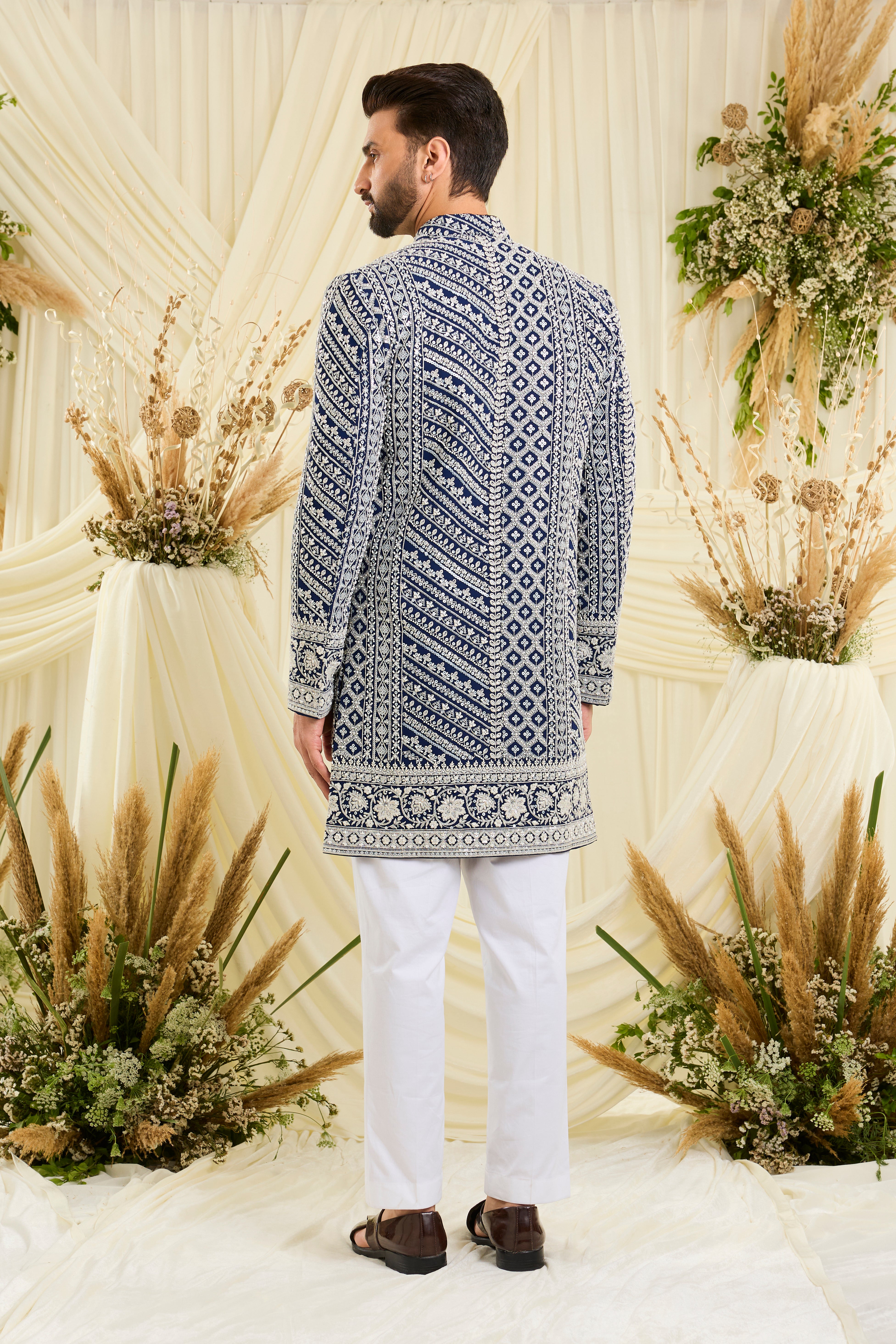 Royal blue short sherwani with intricate white cut dana work and delicate sequins, crafted for a bold, ultra-luxurious statement.