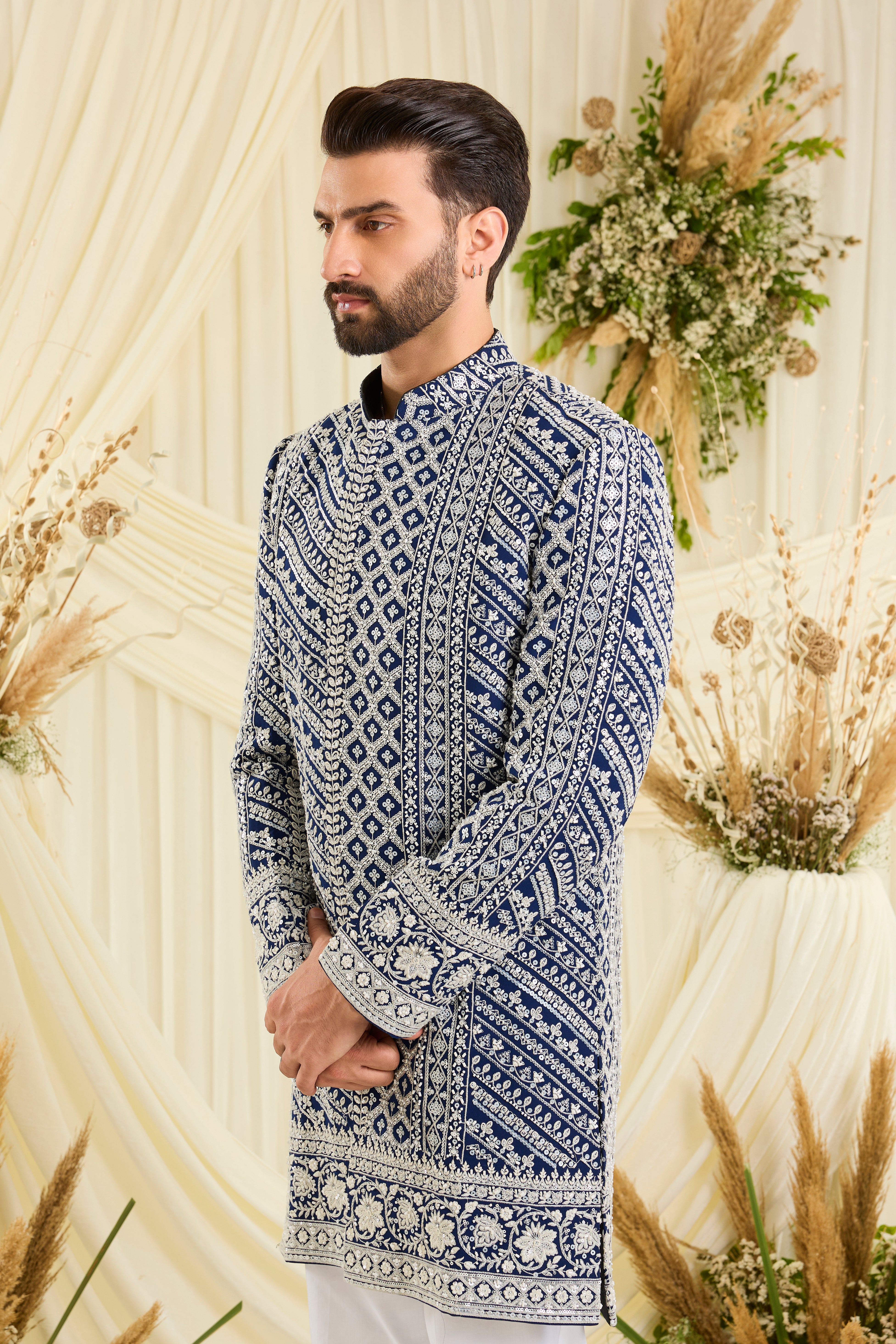Royal blue short sherwani with intricate white cut dana work and delicate sequins, crafted for a bold, ultra-luxurious statement.