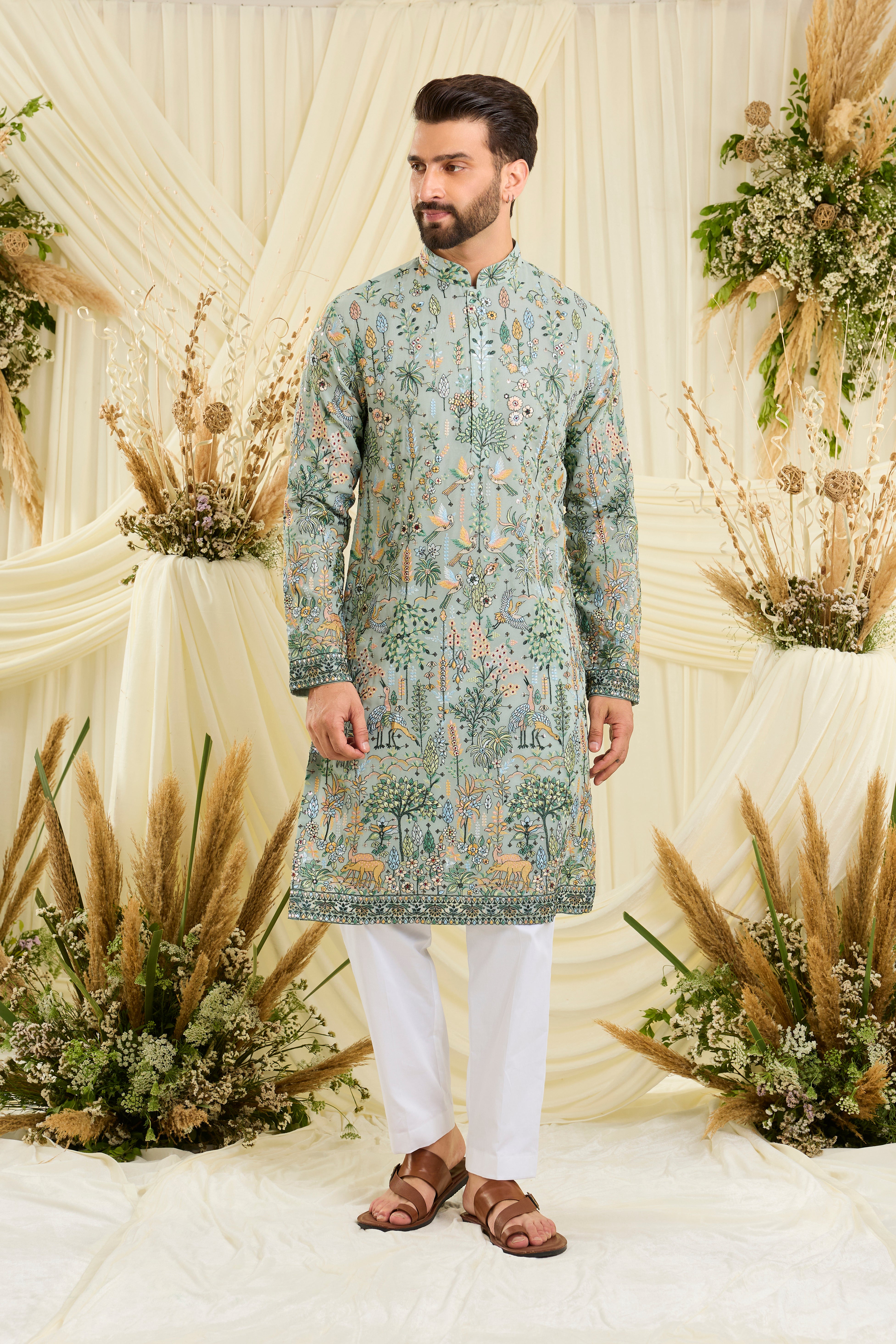 Pastel sage green kurta with intricate flora-fauna embroidery, multicolour threadwork, and delicate sequins for a fresh, elevated festive look.