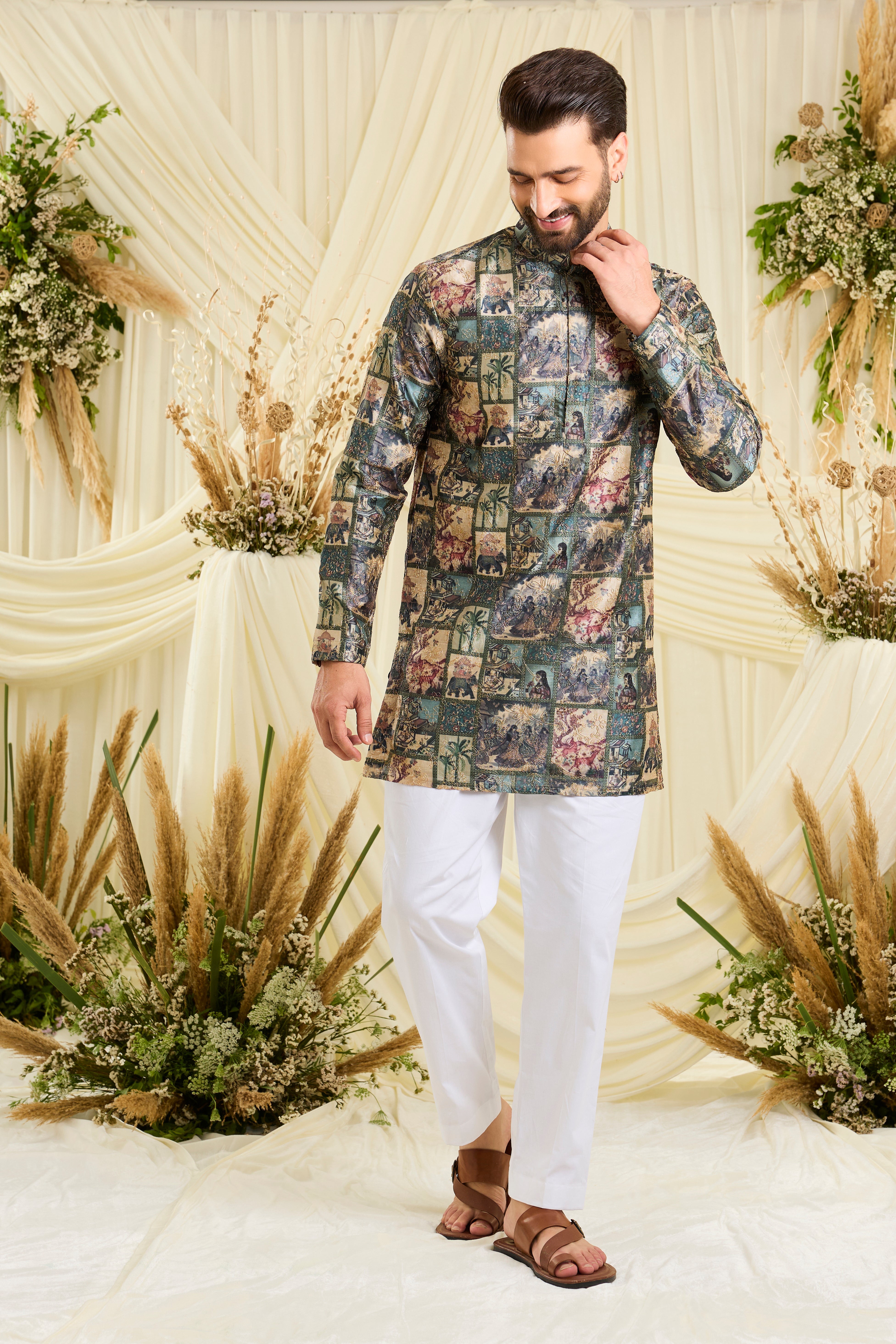 Green short kurta with multicoloured Mughal-era prints, historic motifs,  and intricate aari embroidery for a bold, artistic statement.