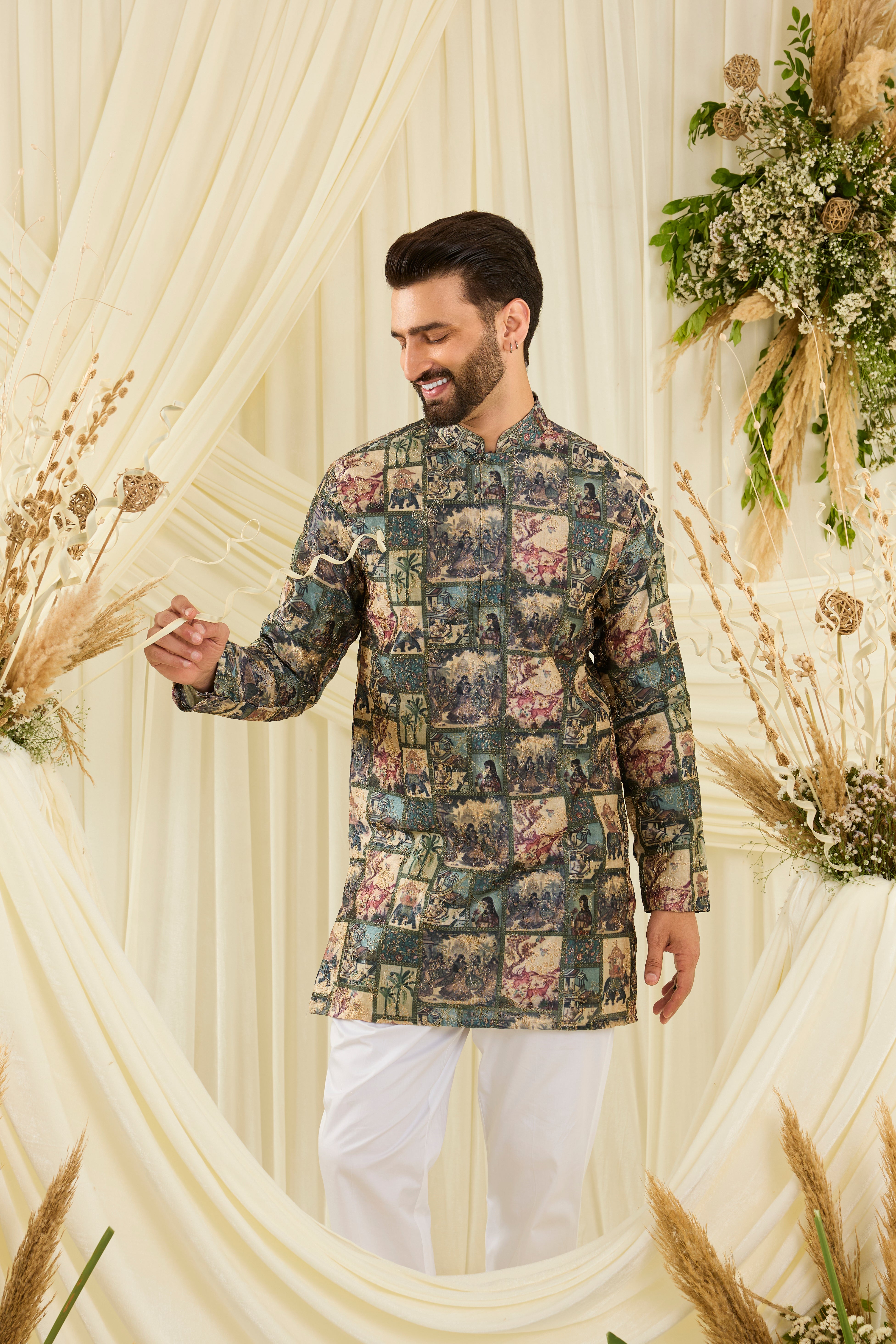 Green short kurta with multicoloured Mughal-era prints, historic motifs,  and intricate aari embroidery for a bold, artistic statement.