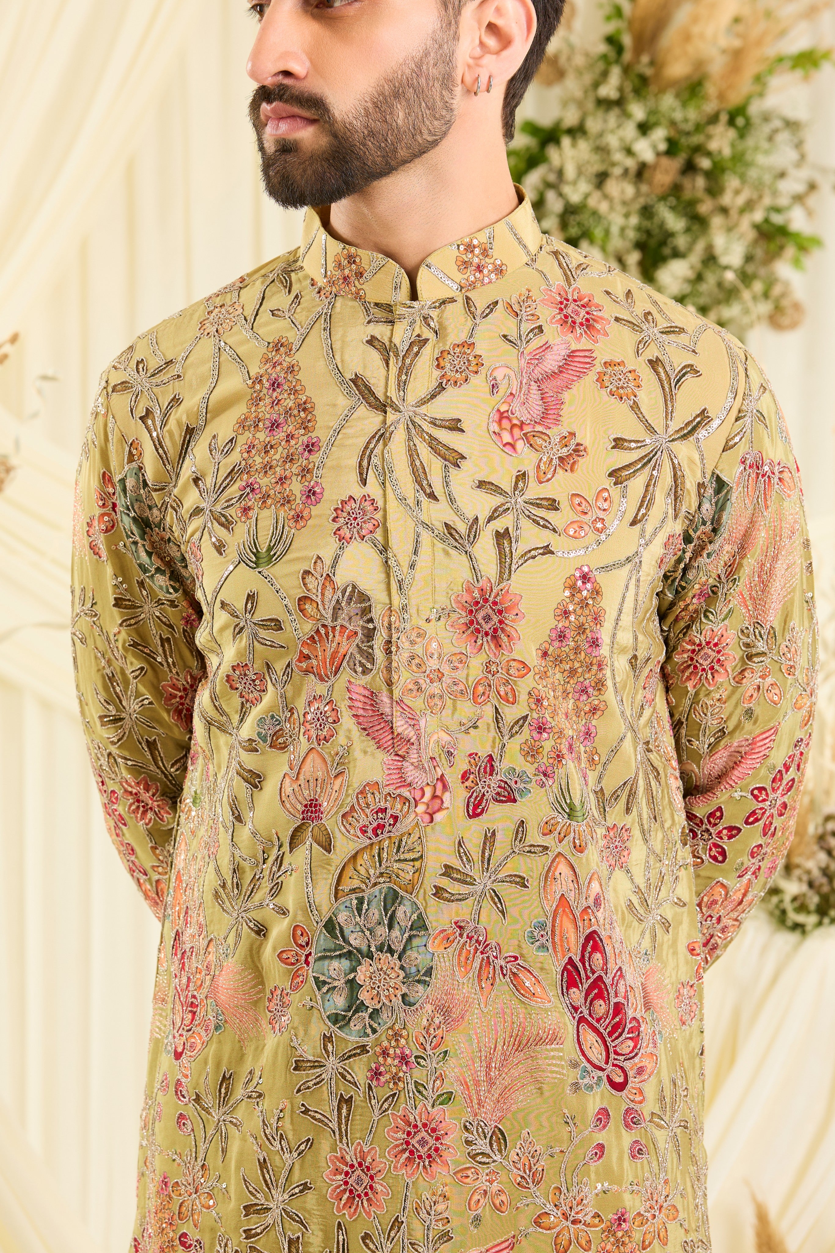 Pastel green kurta with intricate floral embroidery, rich zari detailing, and delicate sequins for a refined, luminous festive statement.