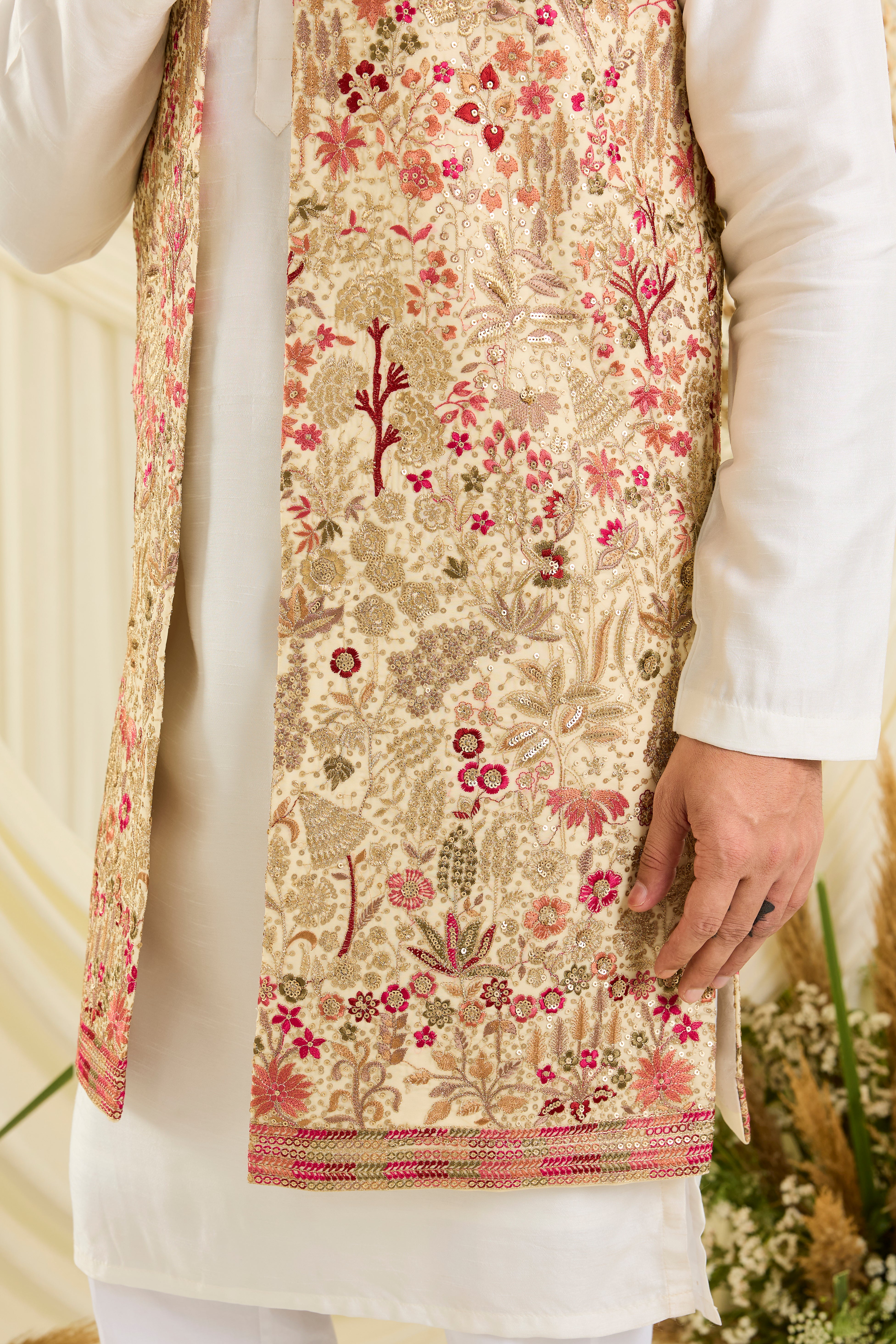 Cream-gold long open jacket with flora-fauna embroidery, multicolour threadwork, and delicate sequins for a rich, elevated couture statement.