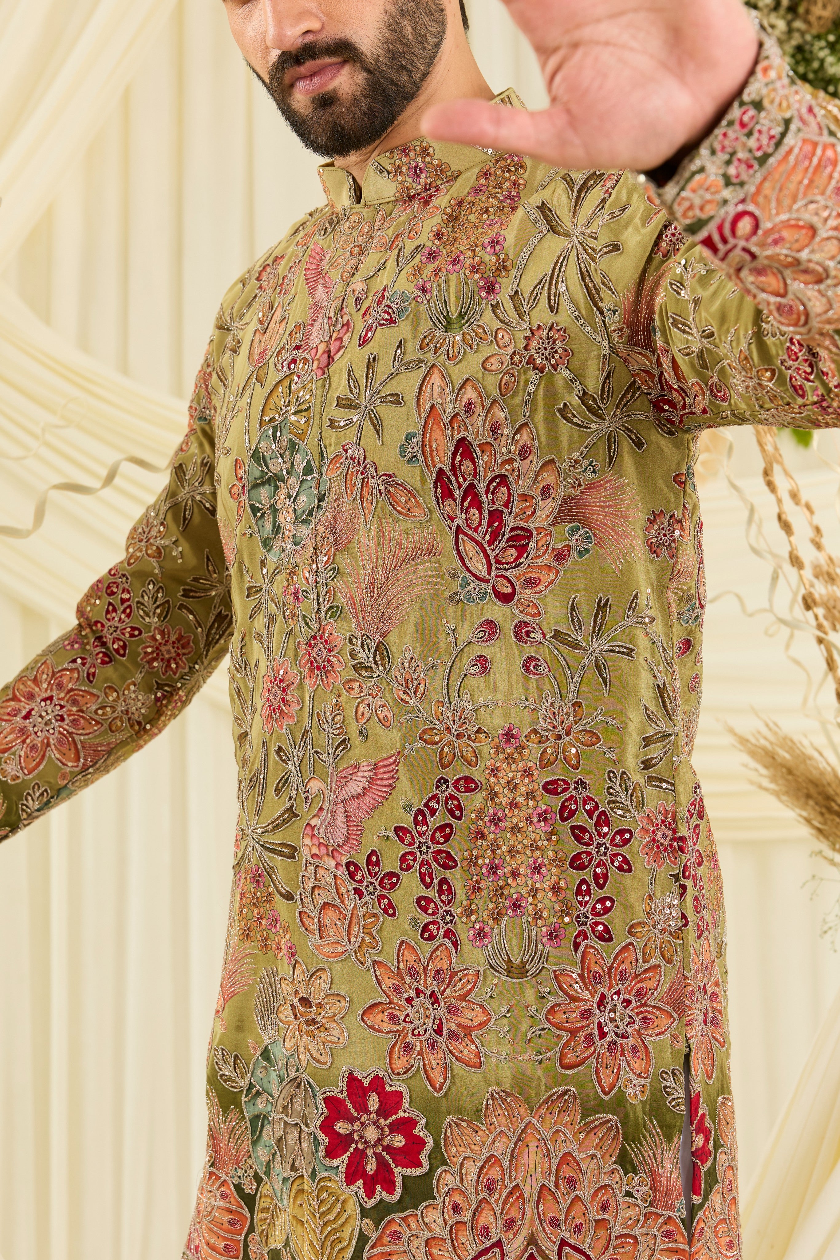 Pastel  green kurta with intricate floral embroidery, rich zari detailing, and delicate sequins for a refined, luminous festive statement.