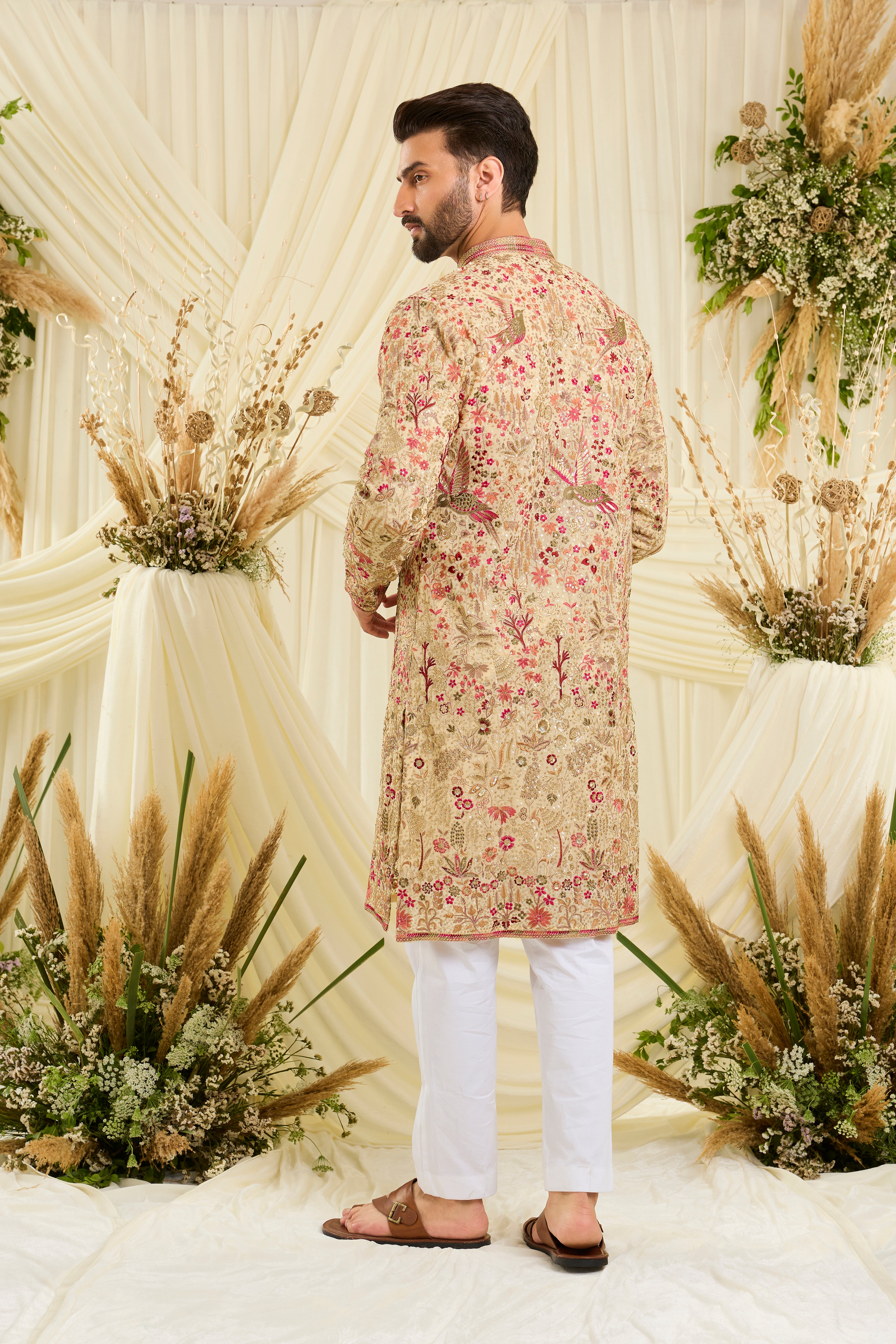 Cream- gold sequined  kurta with intricate flora-fauna embroidery, multicolour threadwork, sequins, and a delicately detailed neckline for elevated festive elegance