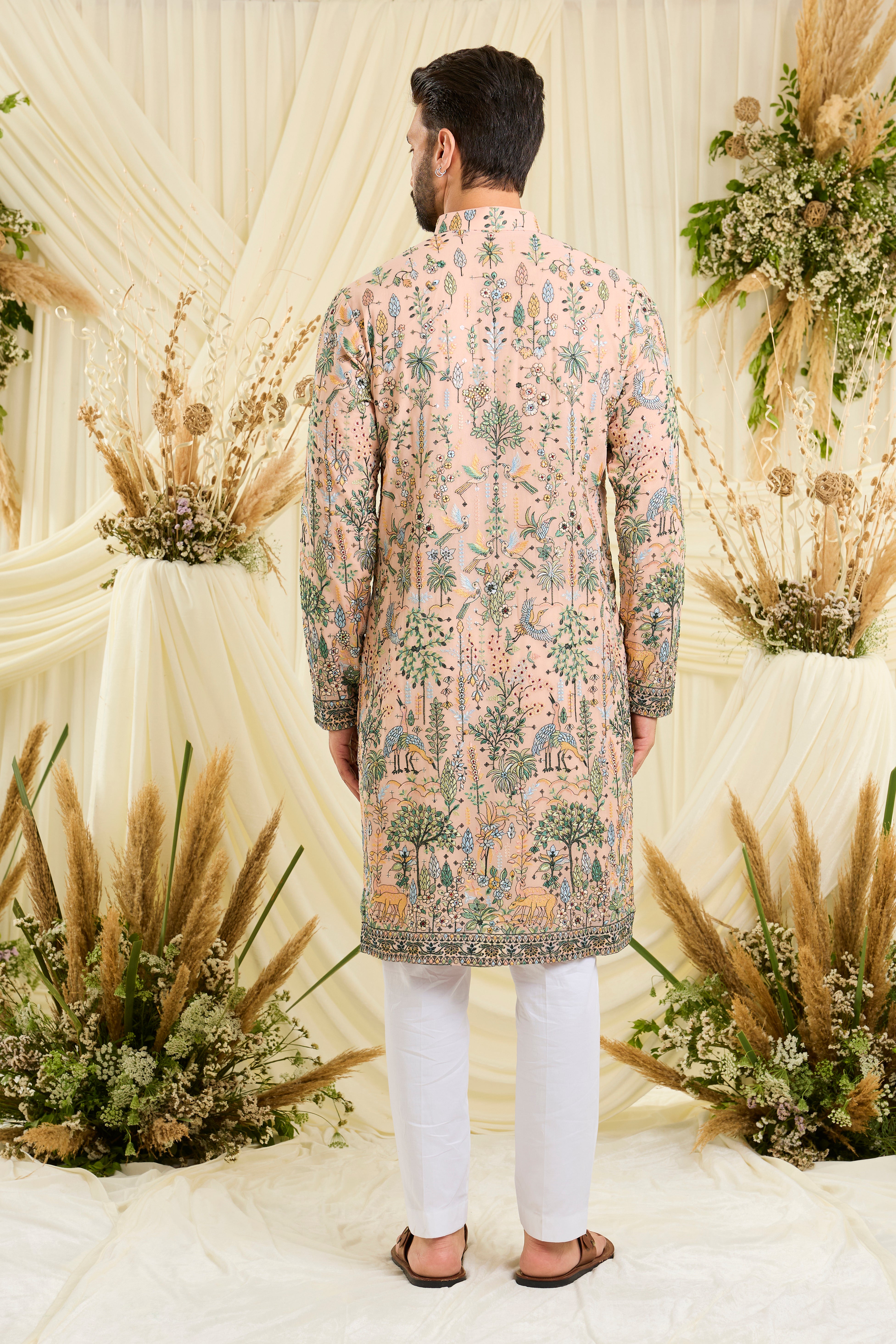 Light peach kurta with intricate flora-fauna embroidery, multicolour threadwork, and delicate sequins for a fresh, elevated festive look.