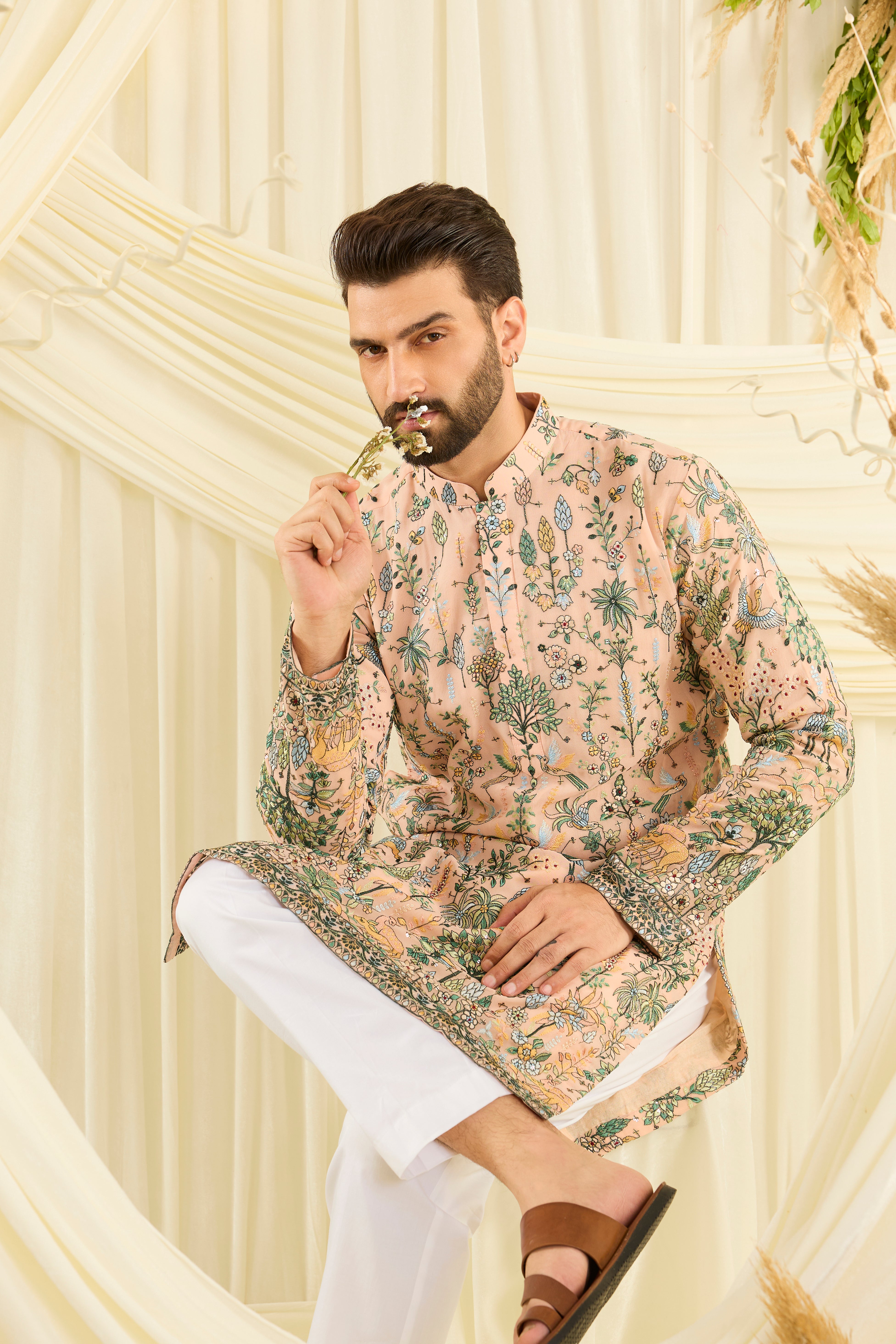 Light peach kurta with intricate flora-fauna embroidery, multicolour threadwork, and delicate sequins for a fresh, elevated festive look.