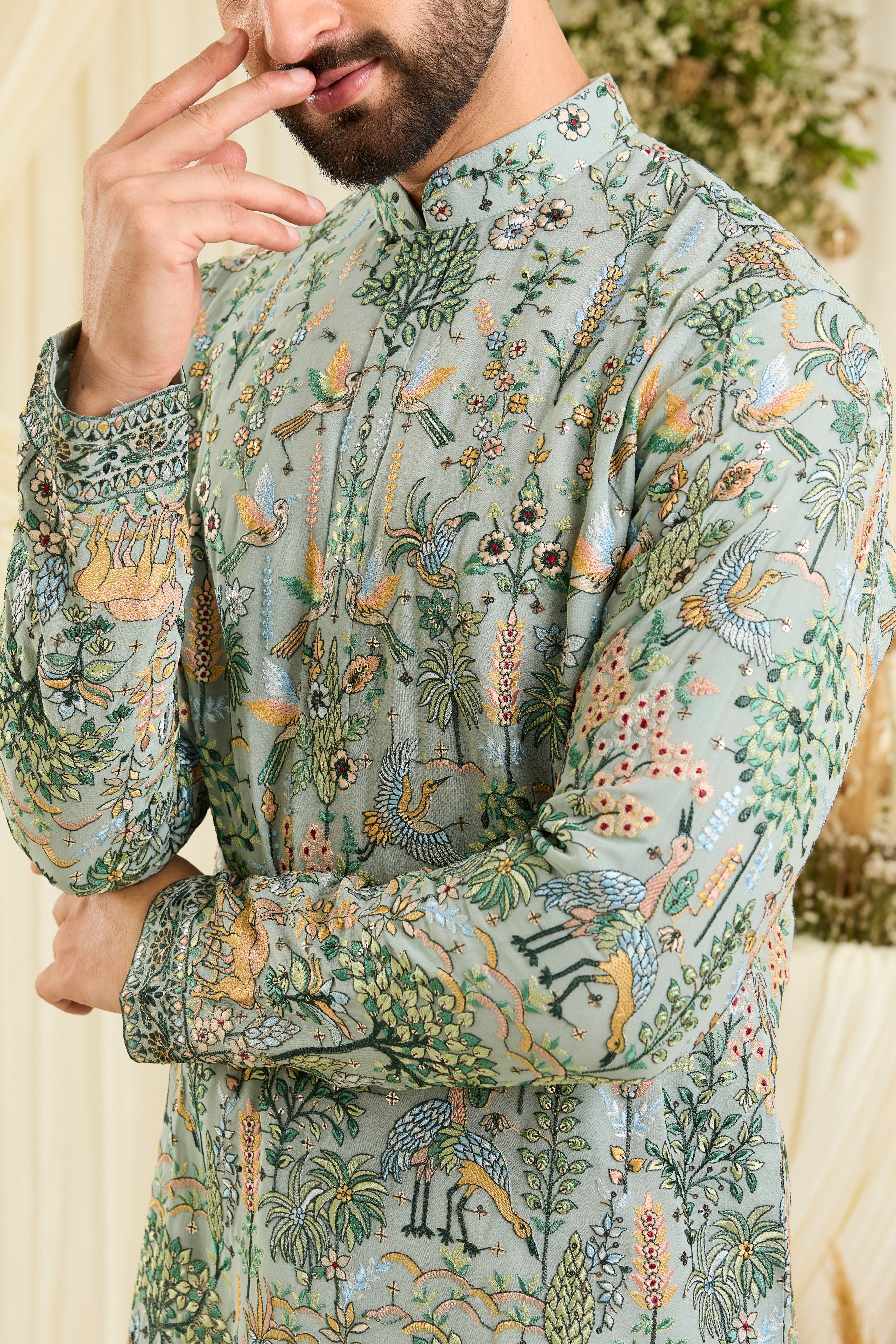 Bluish green short kurta with intricate flora-fauna embroidery, multicolour threadwork, and delicate sequins for a fresh, elevated festive look.