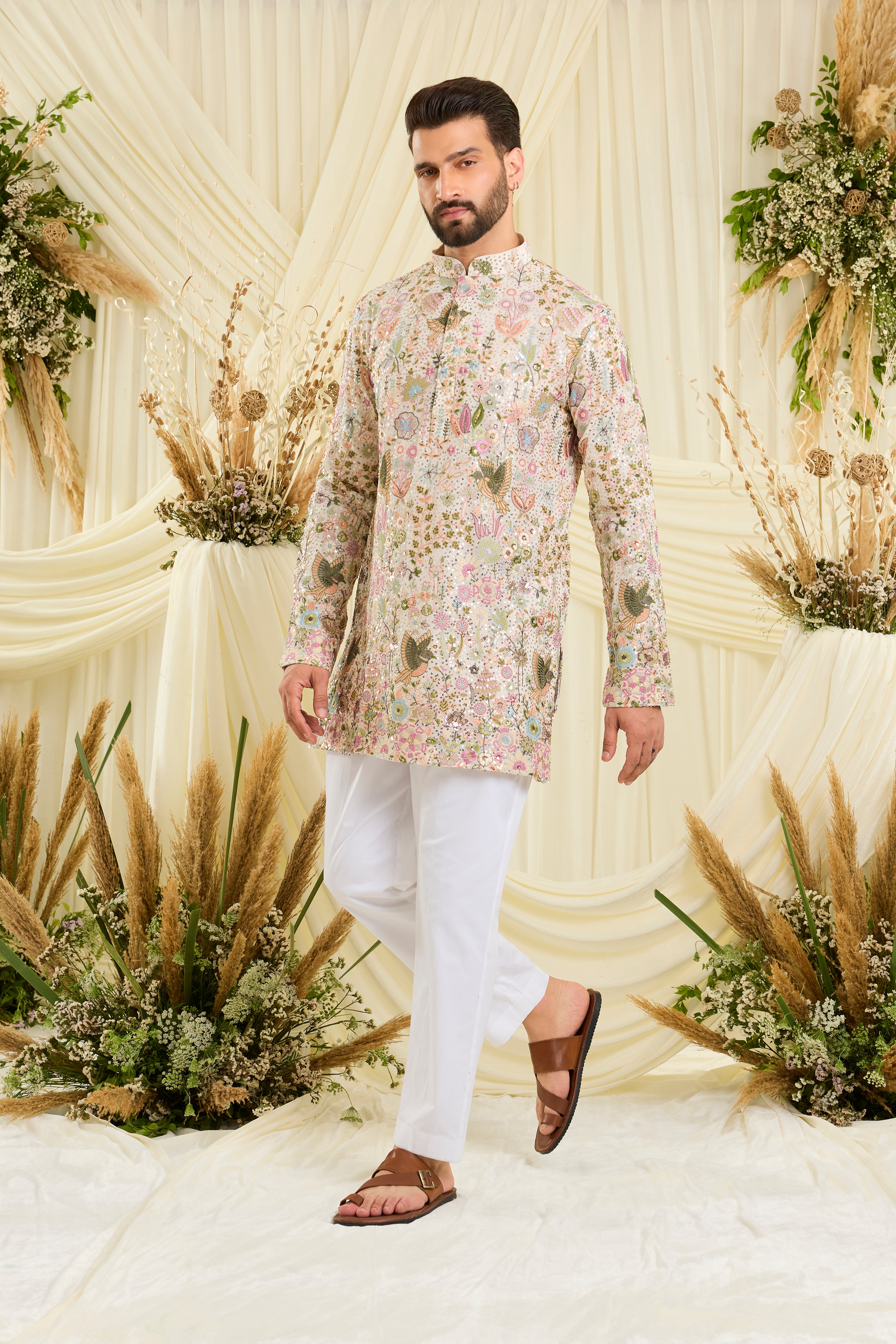 Ivory sequined  short kurta with intricate flora-fauna embroidery, multicolour threadwork, and detailed sequins for a fresh, elevated festive look.