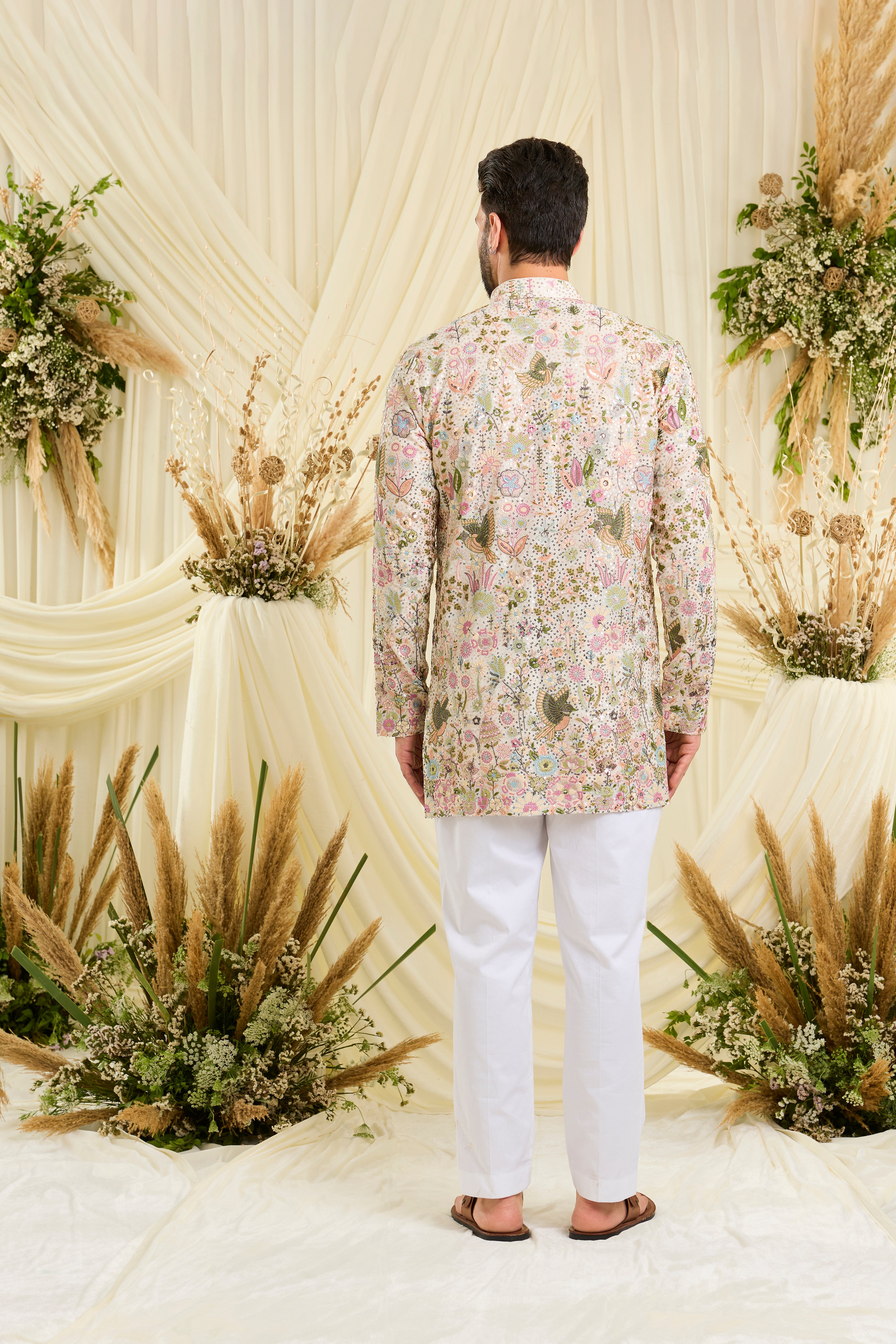 Ivory sequined  short kurta with intricate flora-fauna embroidery, multicolour threadwork, and detailed sequins for a fresh, elevated festive look.
